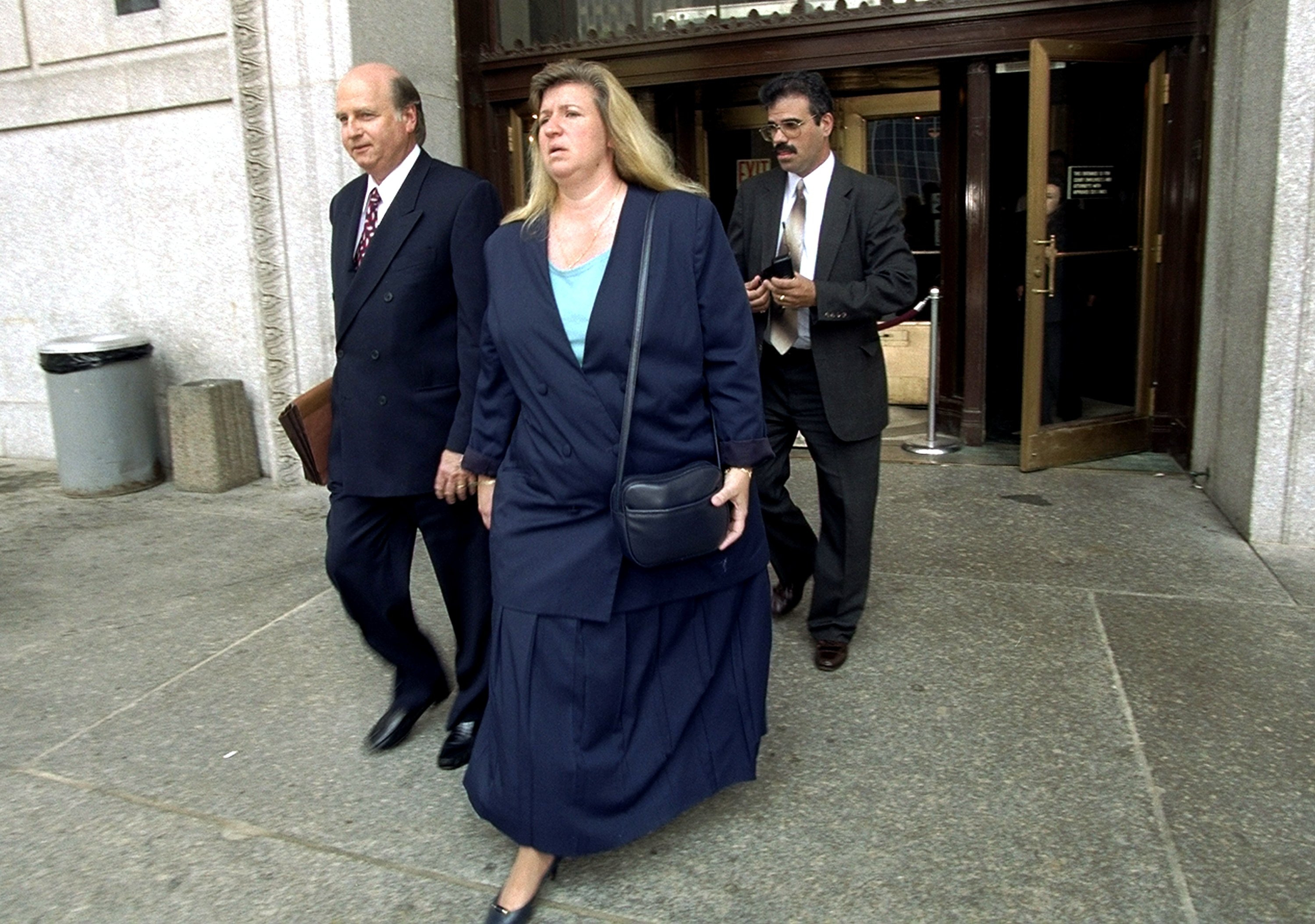Donna and her husband Richard Fasano leaving court with their lawyer. | Source: Getty Images