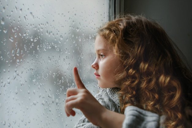 Niña mirando por la ventana / Imagen tomada de: Freepik Niña mirando por la ventana / Imagen tomada de: Freepik