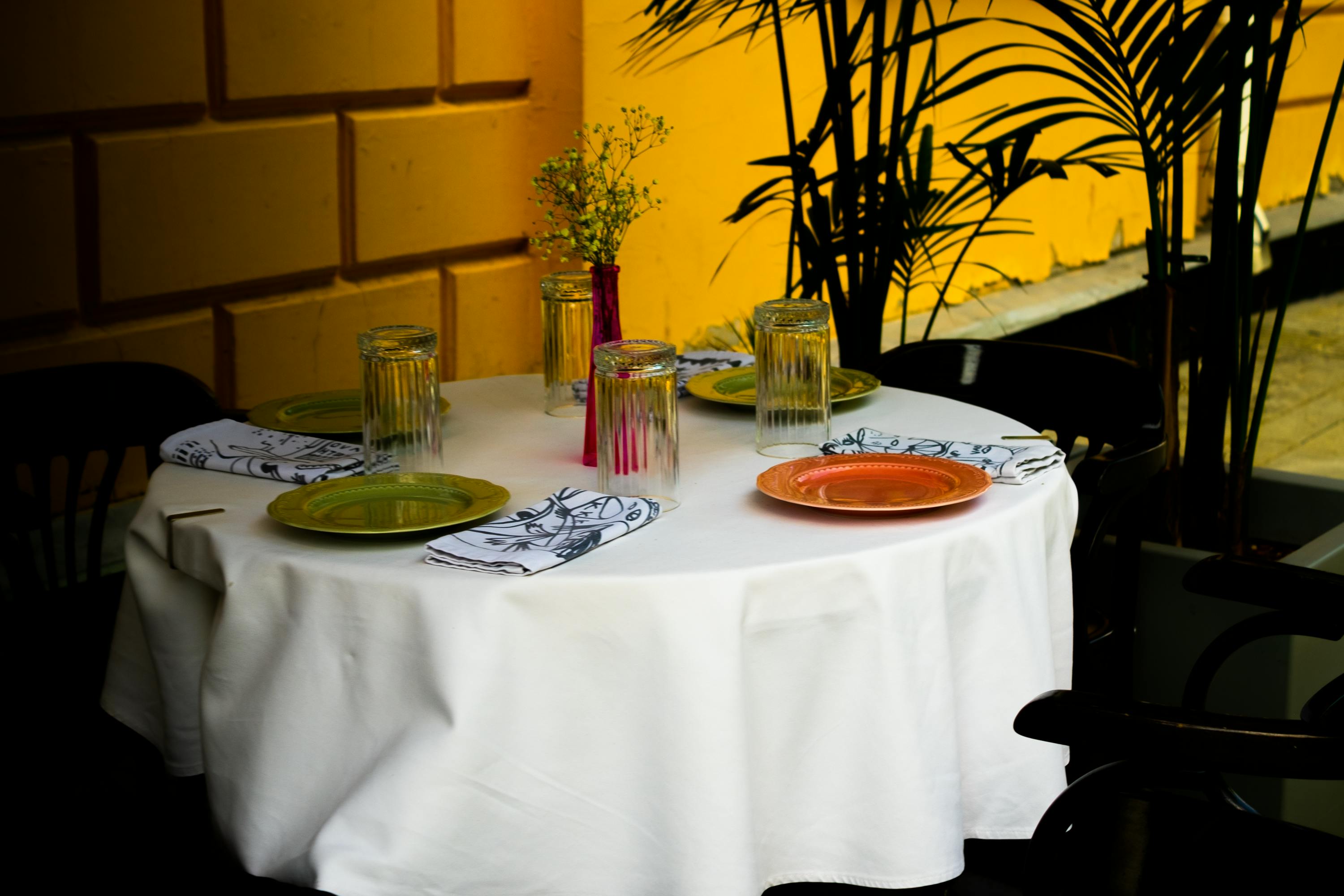 A table with a white tablecloth on top | Source: Pexels