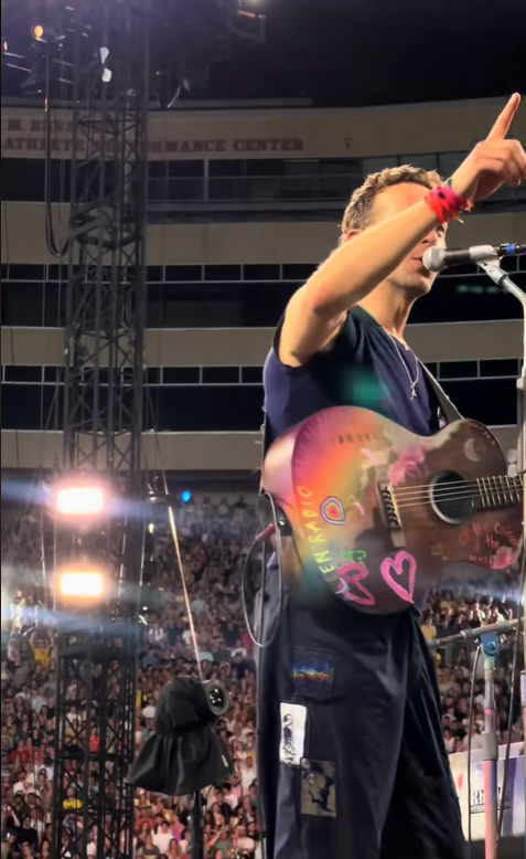 Chris Martin points to the big screen as he made subtle comments about the July 16 concert scandal, from a video post dated July 20, 2025 | Source: TikTok/jarev91