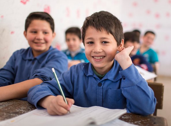 A happy young student in a classroom | Photo: Getty Images