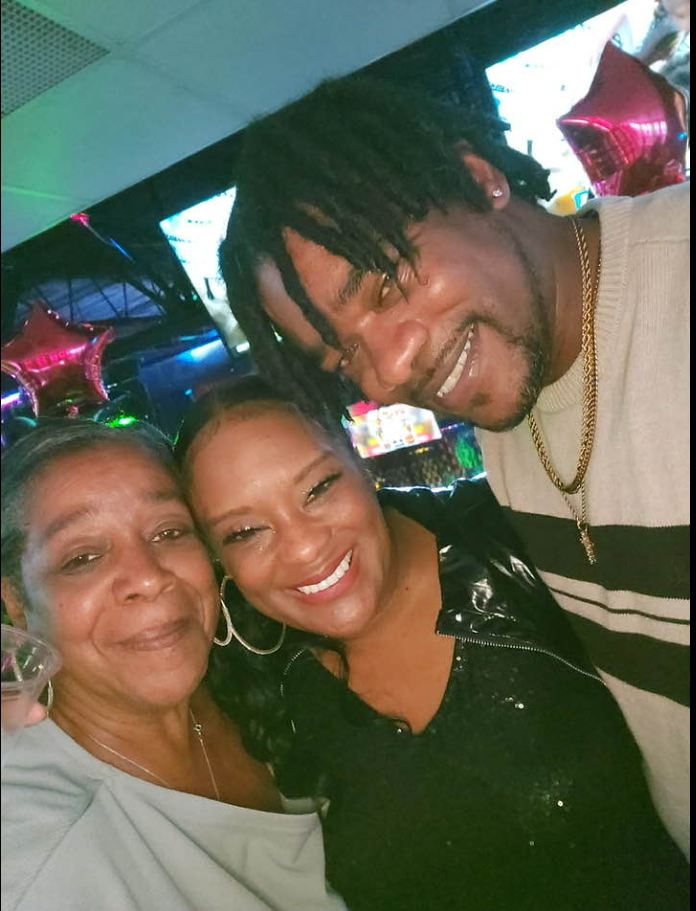 Linda Bryson-Thigpen, center, smiles alongside family members and loved ones in an undated photo. The gathering was among the moments she later reflected on while navigating life after her mother's death. | Source: Facebook/Linda Bryson-Thigpen