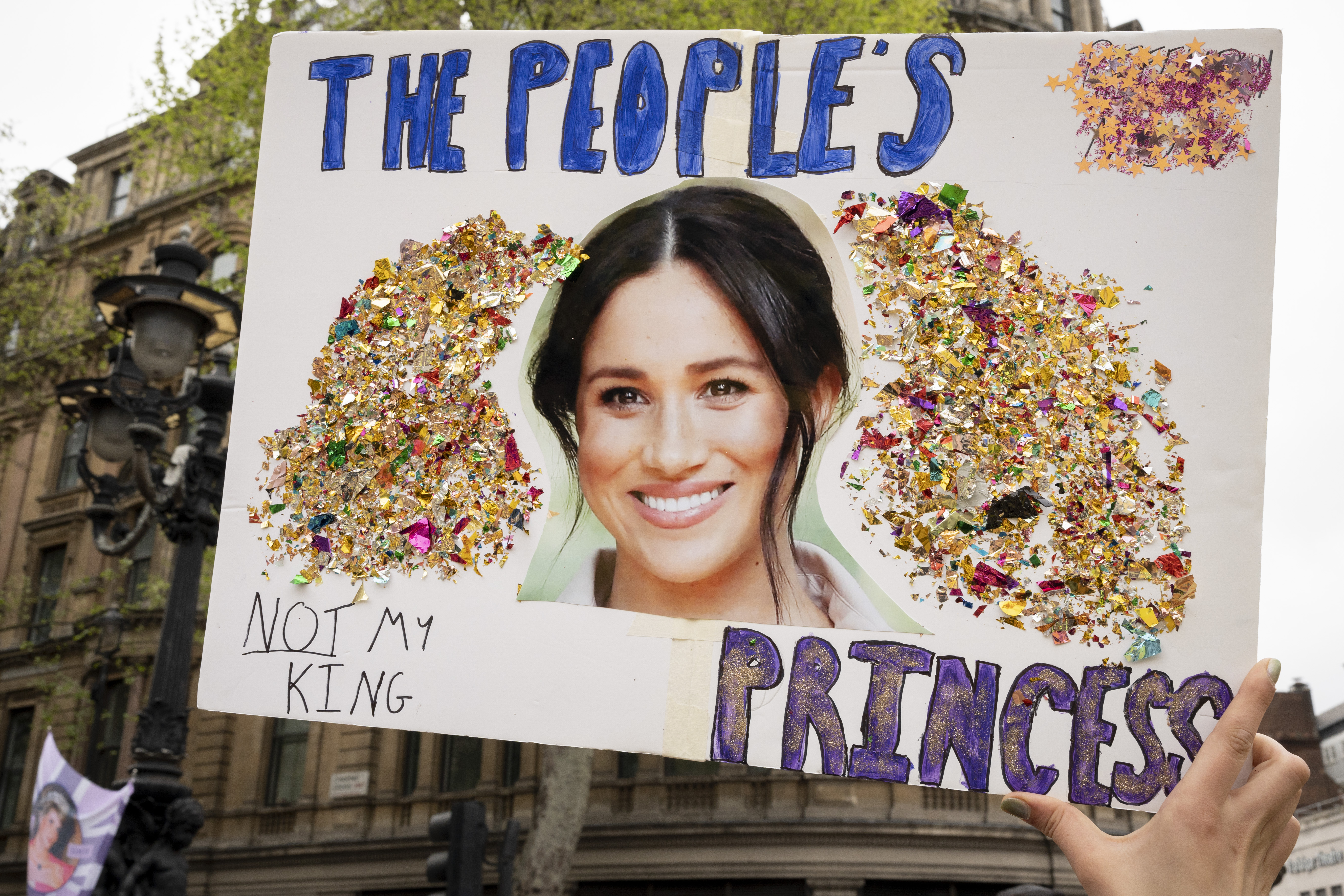 A member of the anti-monarchist group 'Republic' protests with an image of Meghan, Duchess of Sussex on 6th May 2023, in London, England. | Source: Getty Images
