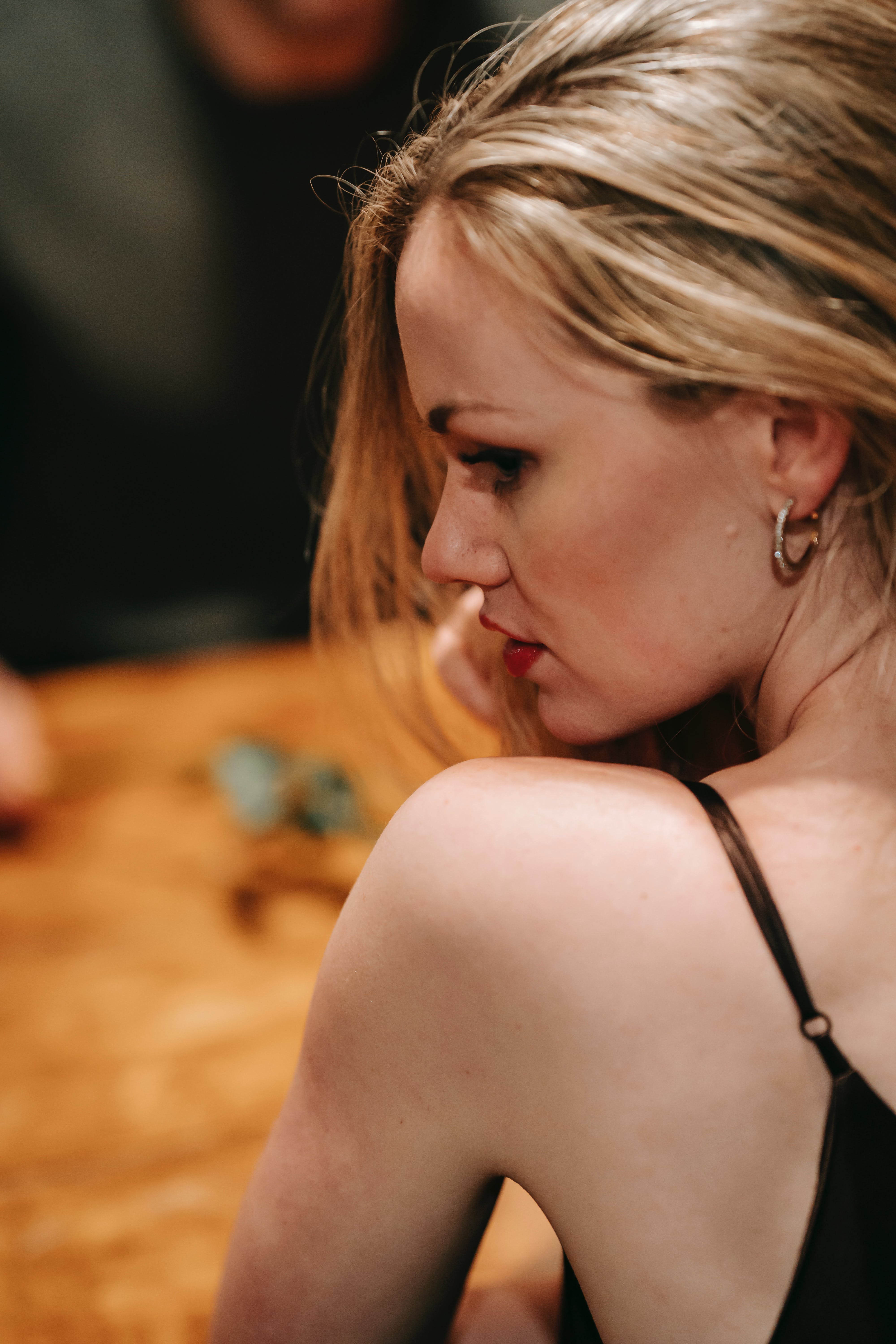 An upset woman looking away with her partner in the background | Source: Pexels