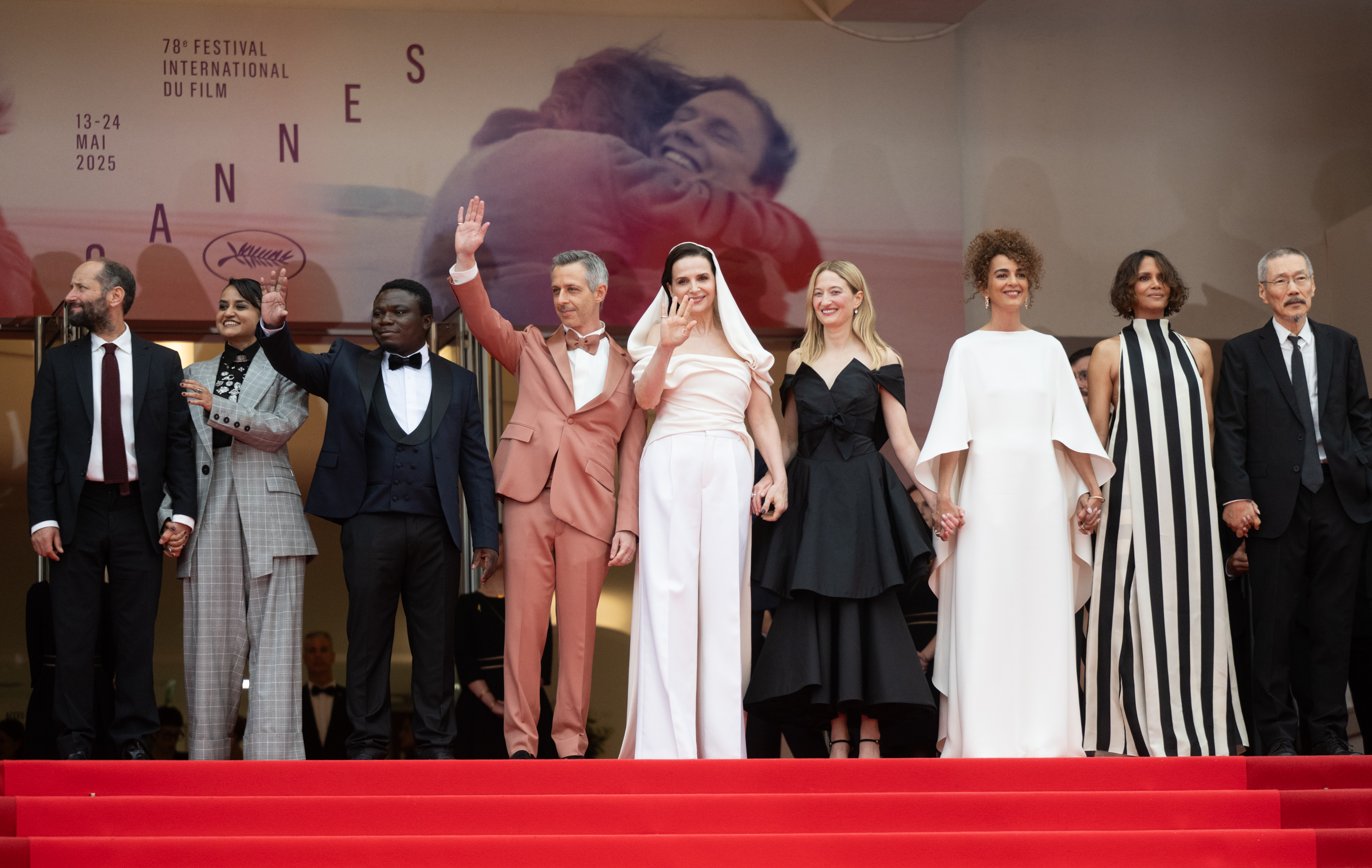Halle Berry stands poised alongside her fellow jury members at the Cannes Film Festival, the group united in elegance and authority as they face the cameras. Her presence adds star power to the distinguished lineup, capturing a moment of cinematic prestige