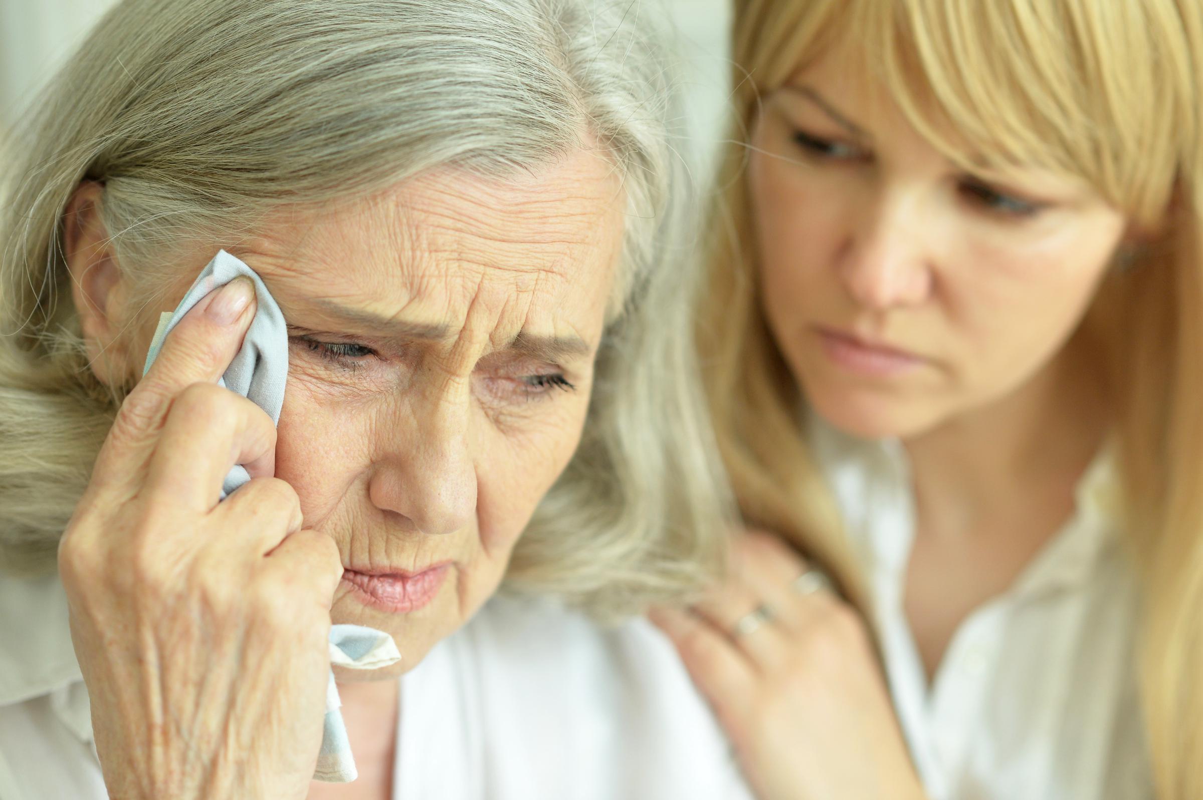 A young woman consoling a grieving older woman | Source: Shuttestock