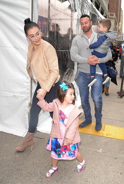 Roger Mathews, Jenni 'JWoww' Farley and Meilani Mathews walking Midtown in New York City.| Photo: Getty Images.