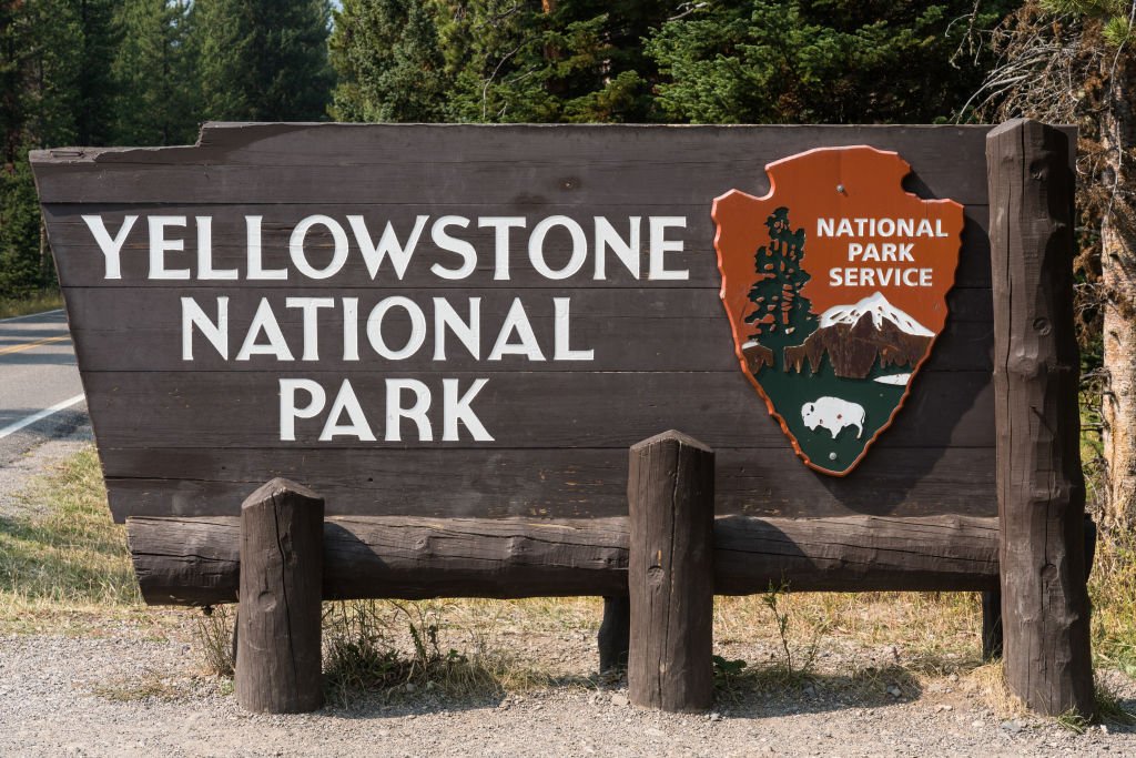 A portrait of the wooden entrance sign to Yellowstone National Park, USA on September 16, 2020 | Photo: Getty Images