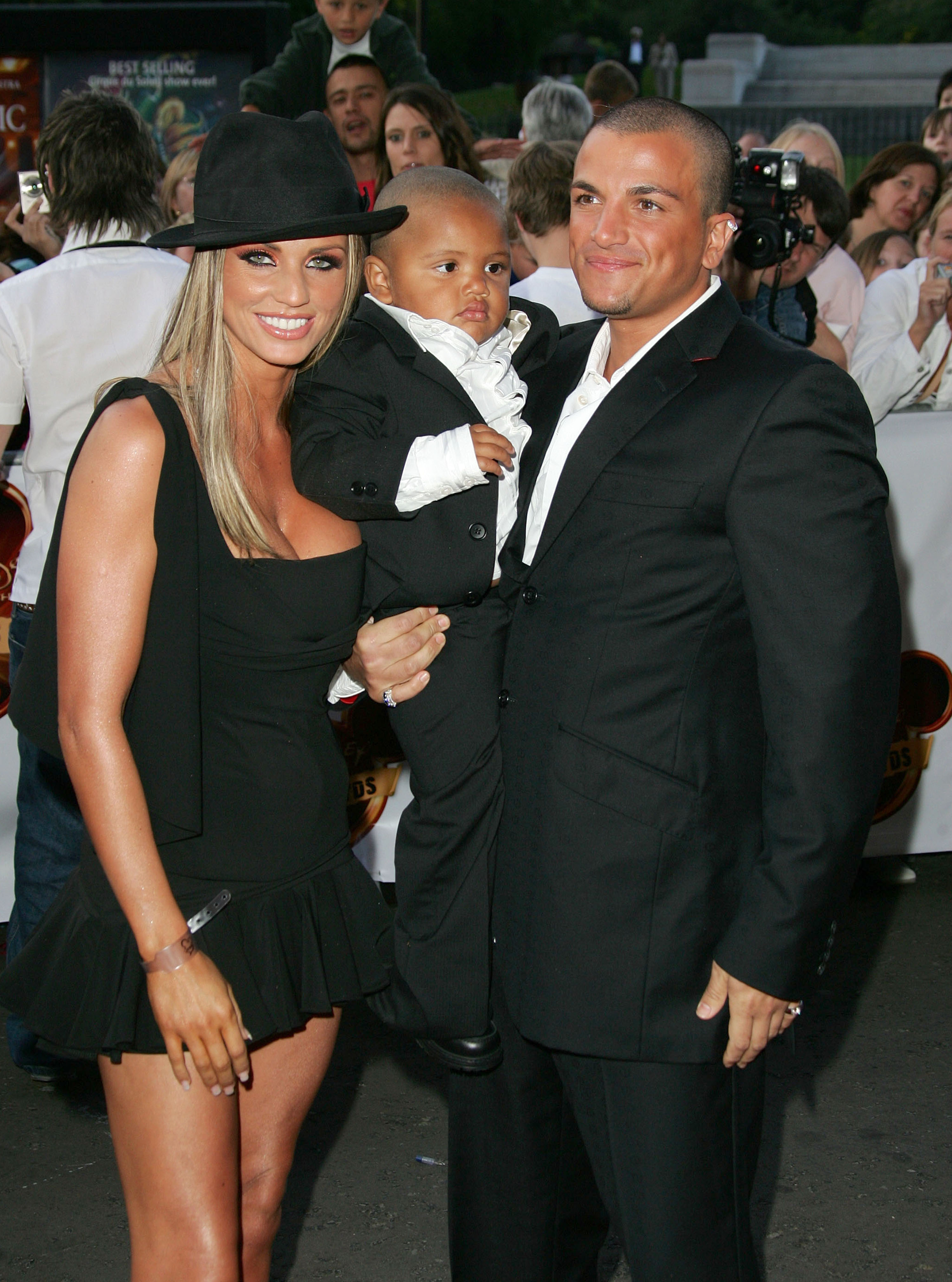 Katie Price, Peter Andre, and a dapperly dressed Harvey Price pose as a family at the 2004 Disney Channel Kids Awards in London on September 16. It was a rare moment of public unity, with Peter embracing the role of stepfather during the early days of his relationship with Katie and her young son.