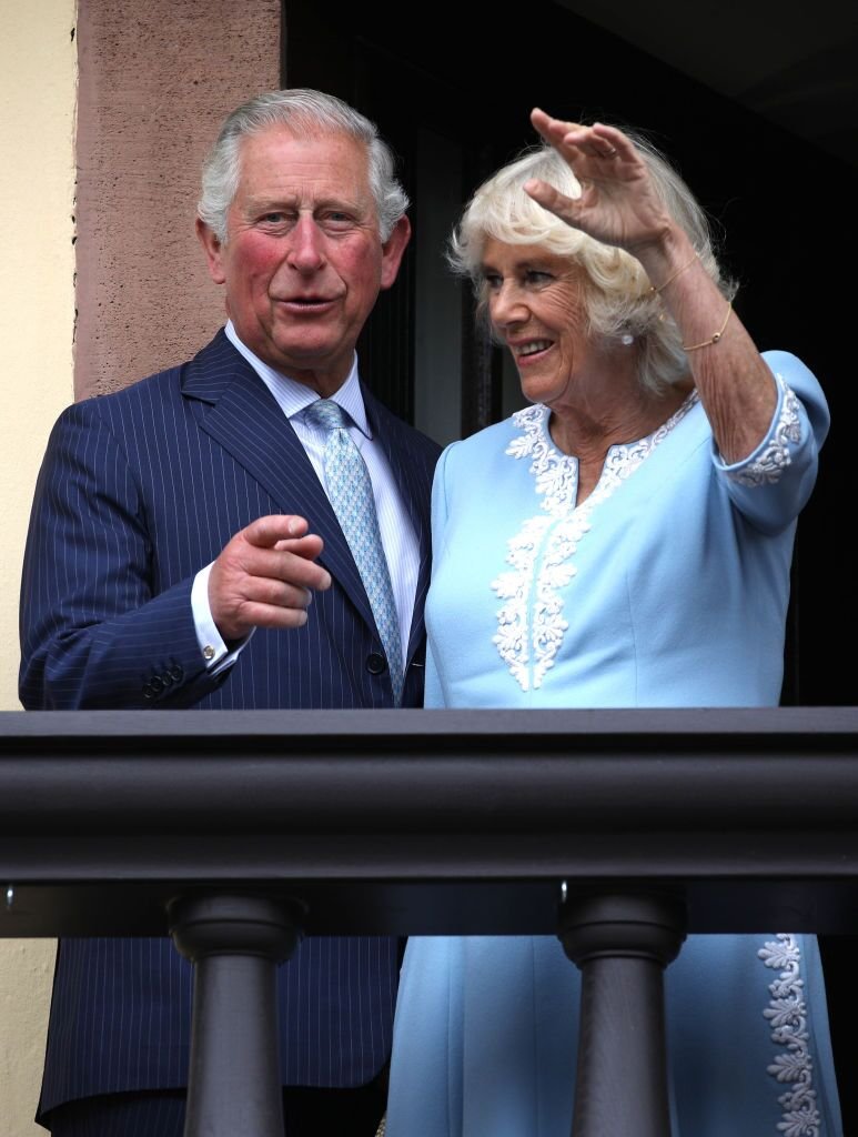 Prince Charles, Prince of Wales and Camilla, Duchess of Cornwall wave to the crowd from the balcony at Old City Hall. | Source: Getty Images