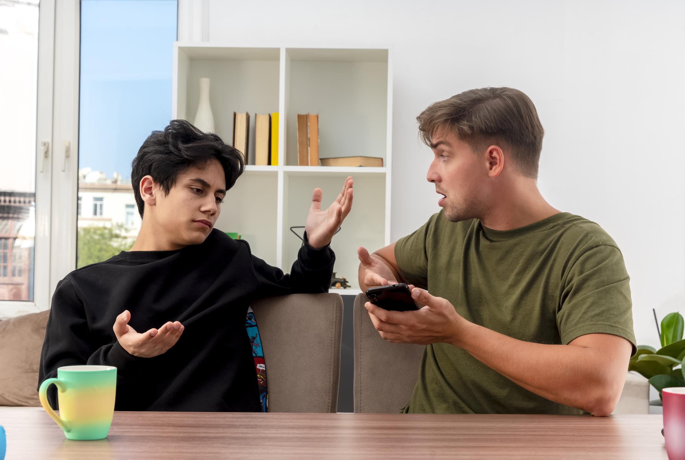 Two men arguing at home | Source: Freepik