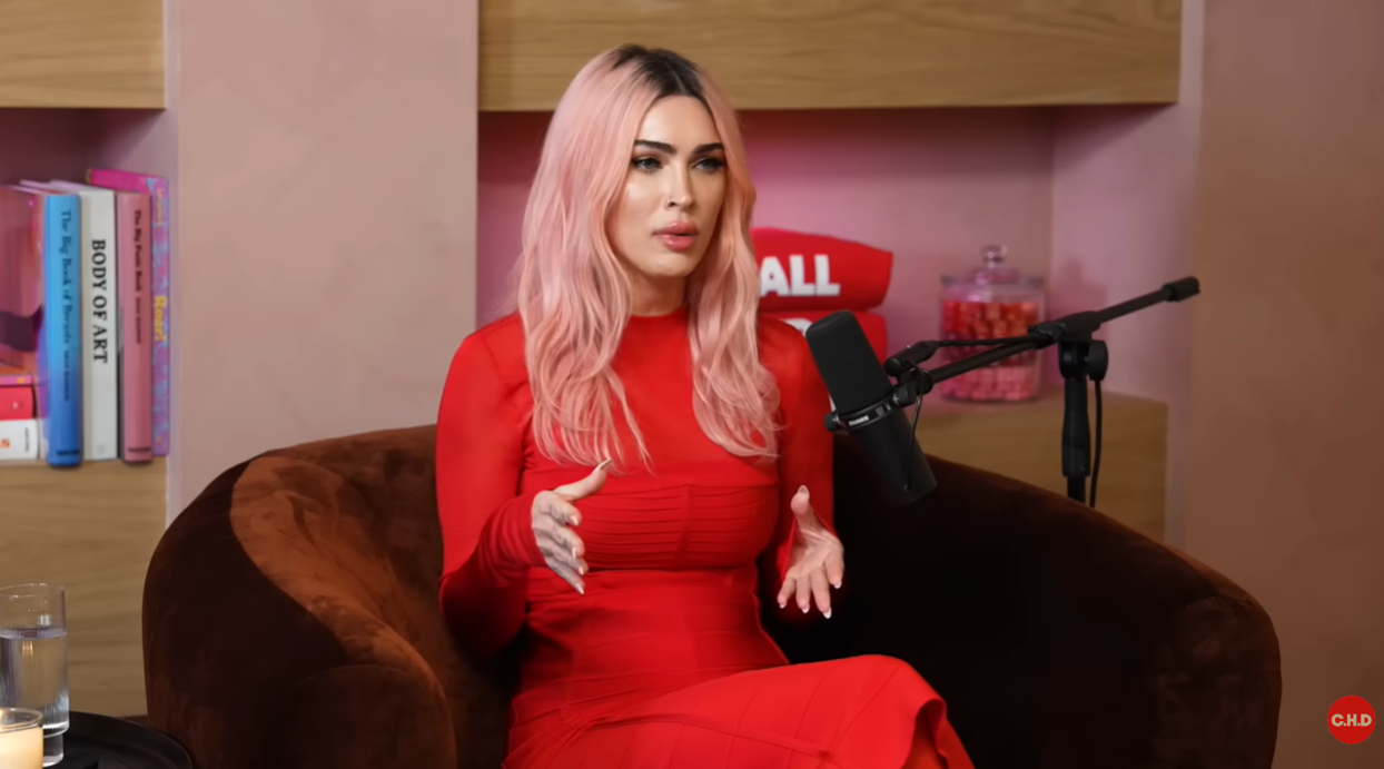 Megan Fox gestures with her hands while discussing cosmetic procedures during the podcast | Source: YouTube/callherdaddy