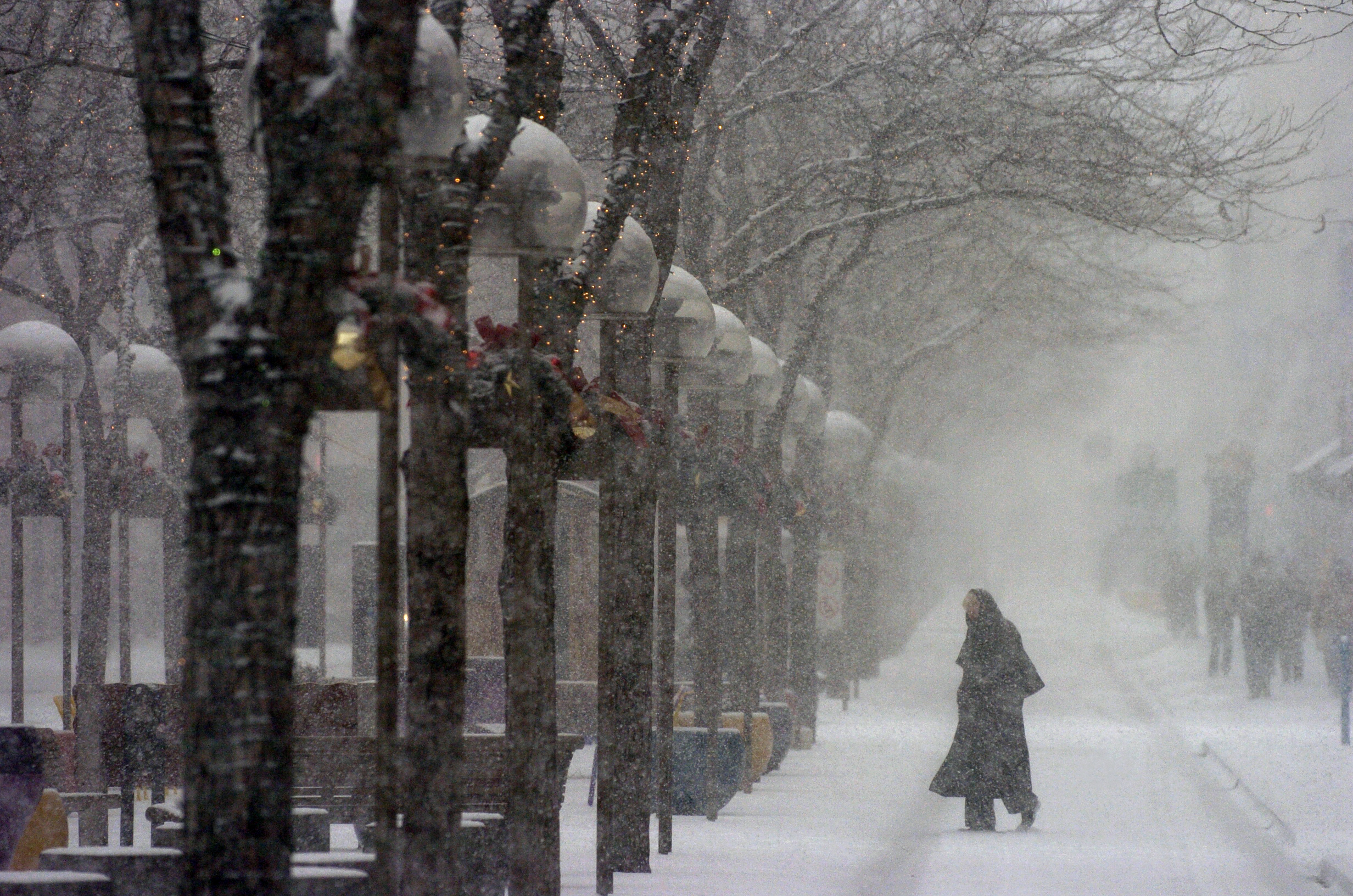 A pedestrian photographed along the 16th Street Mall during snow storm in downtown on December 6, 2005, in Denver, Colorado. | Source: Getty Images