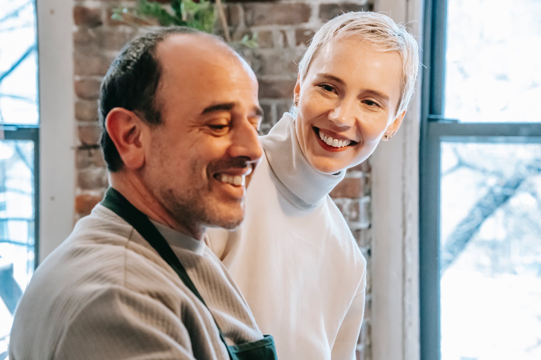 A woman smiling at a smiling man beside her. | Source: Pexels