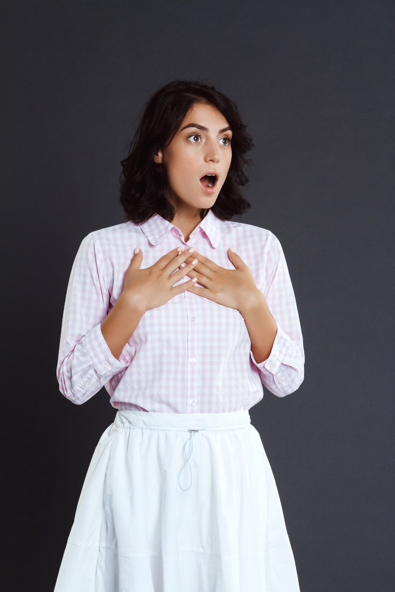 A woman acting surprised and innocent with her hands on her chest | Source: Pexels