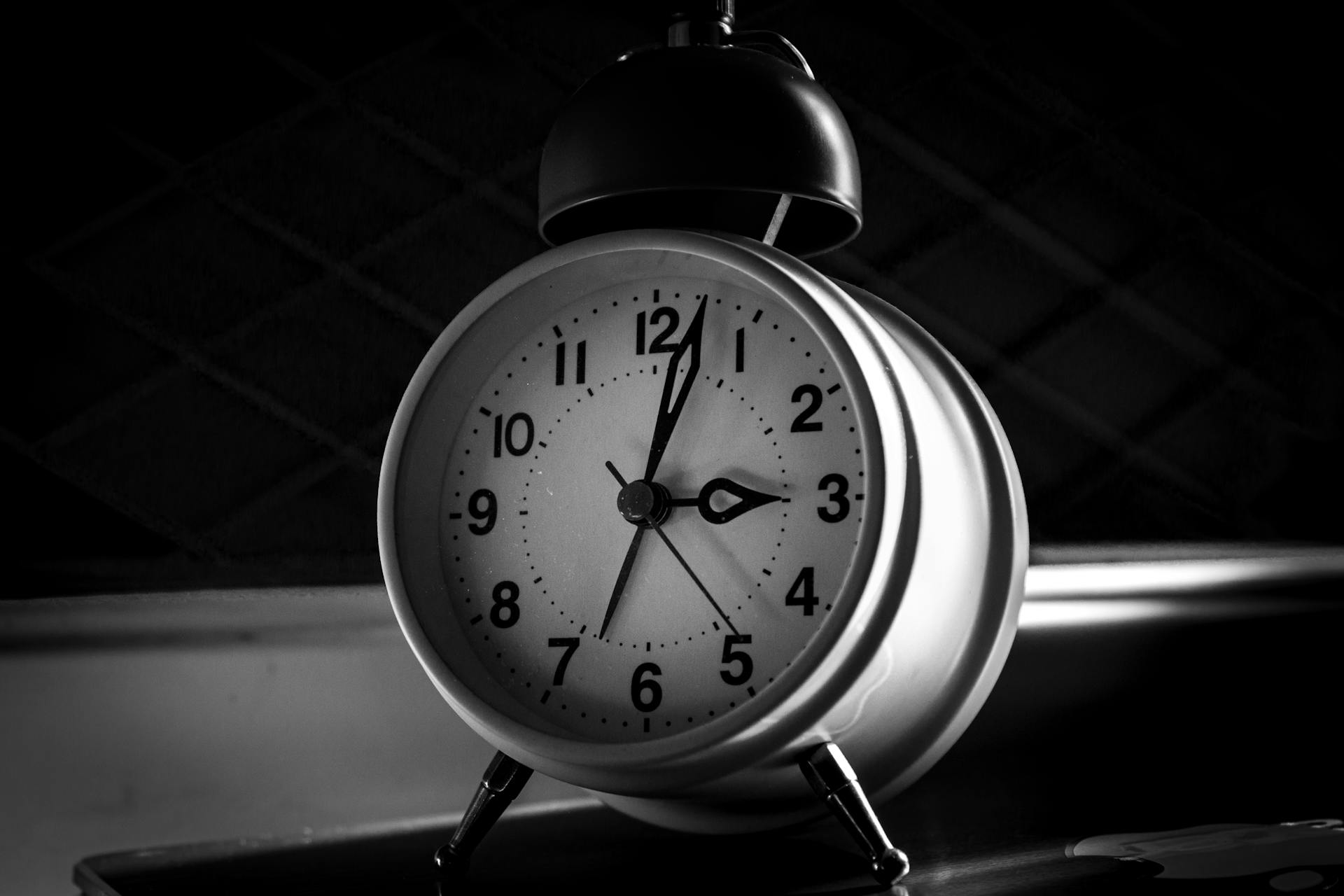 Grayscale photo of an alarm clock | Source: Pexels