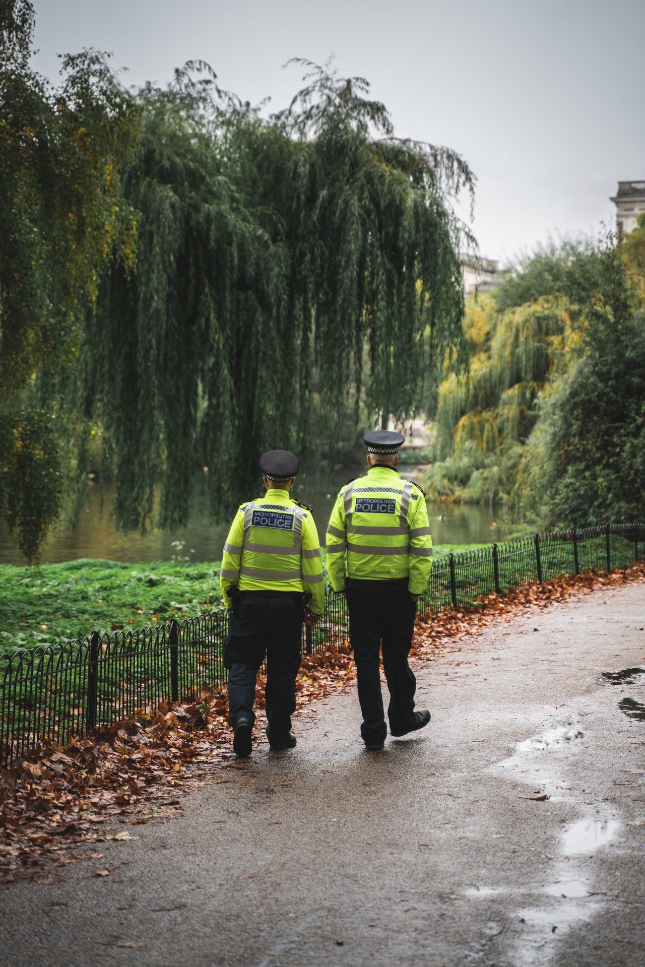 Two police officers walking down a pathway. | Photo: Pexels