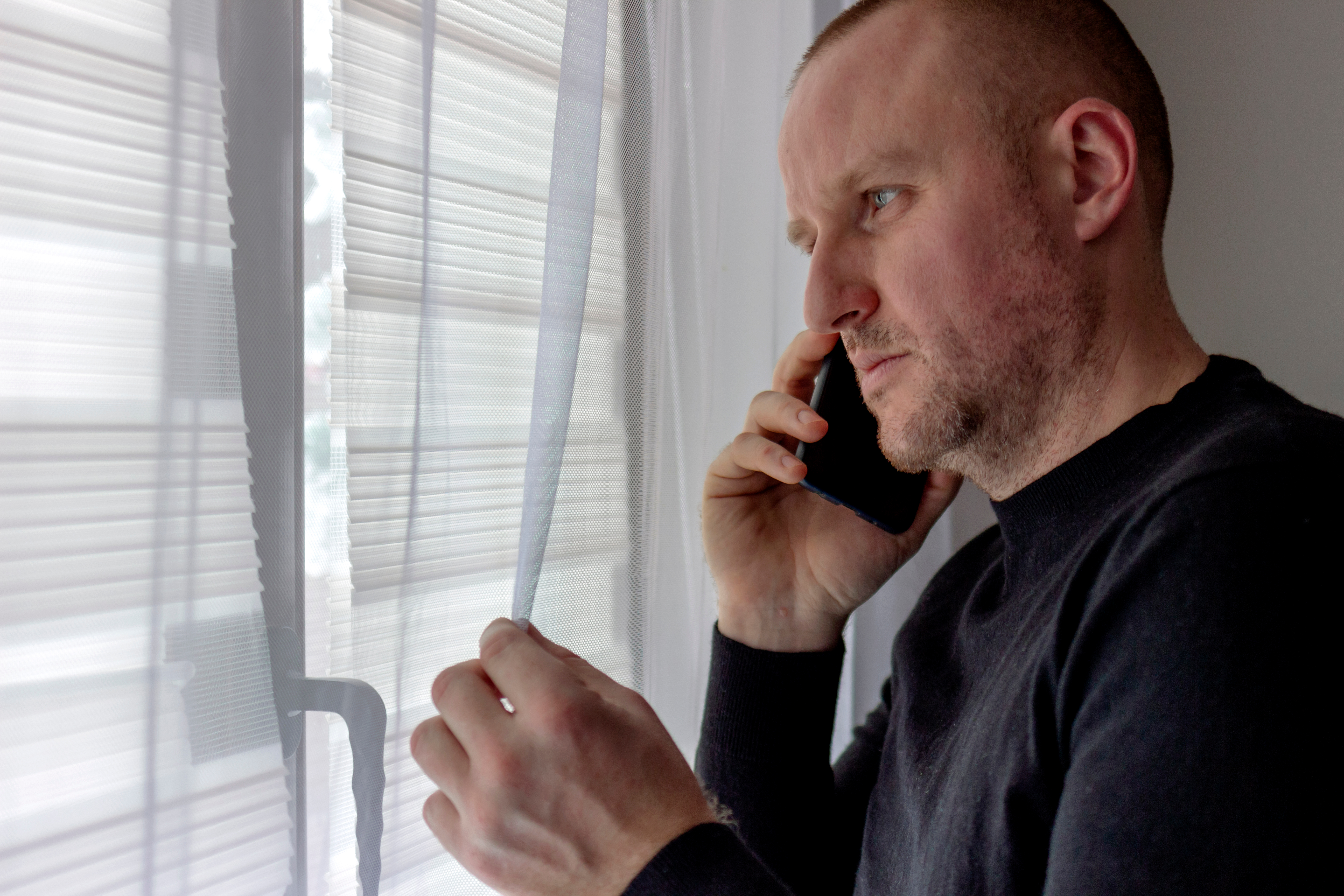 A man looking worried while on the phone | Source: Shutterstock