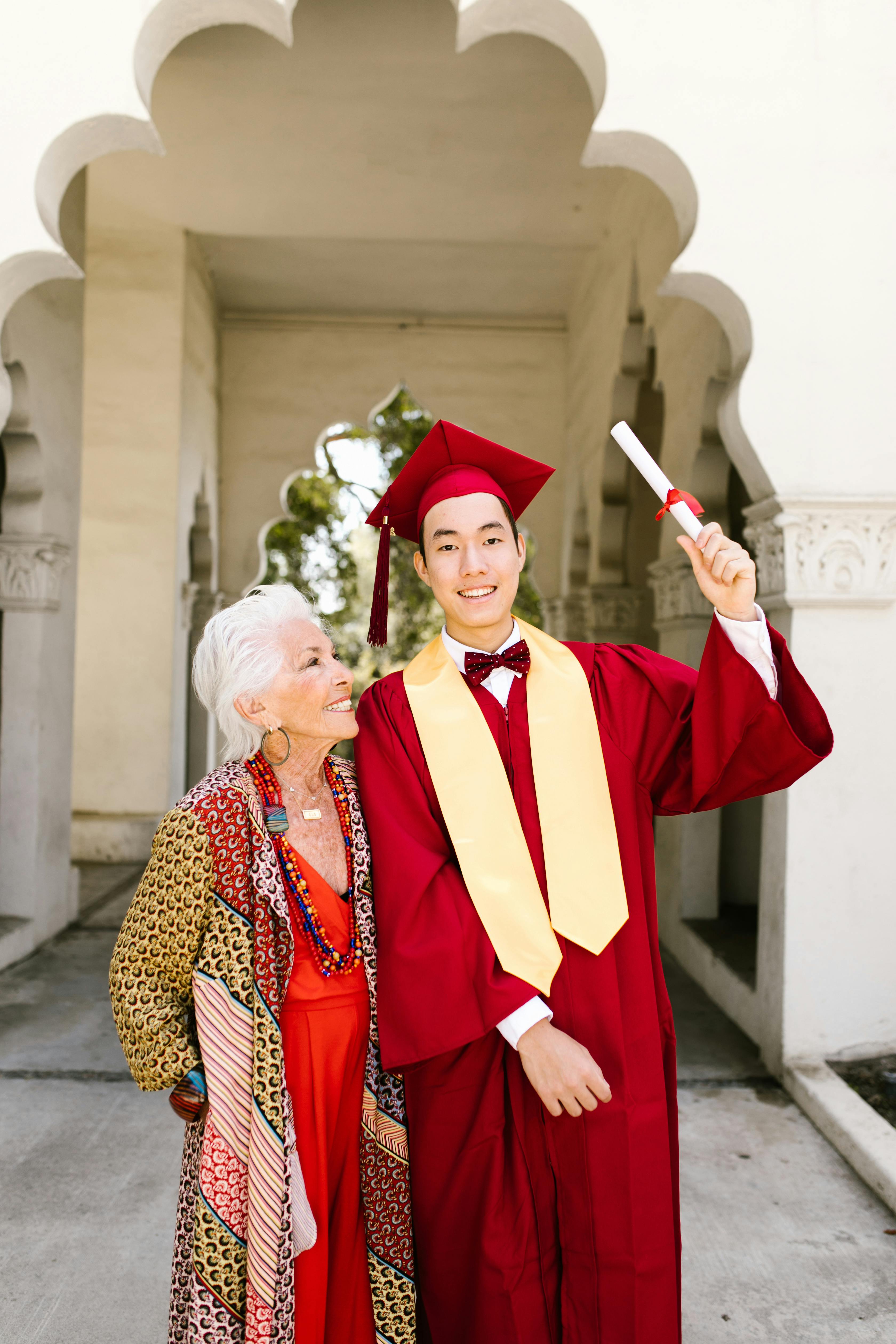 Man graduating with his mother by his side | Source: Pexels