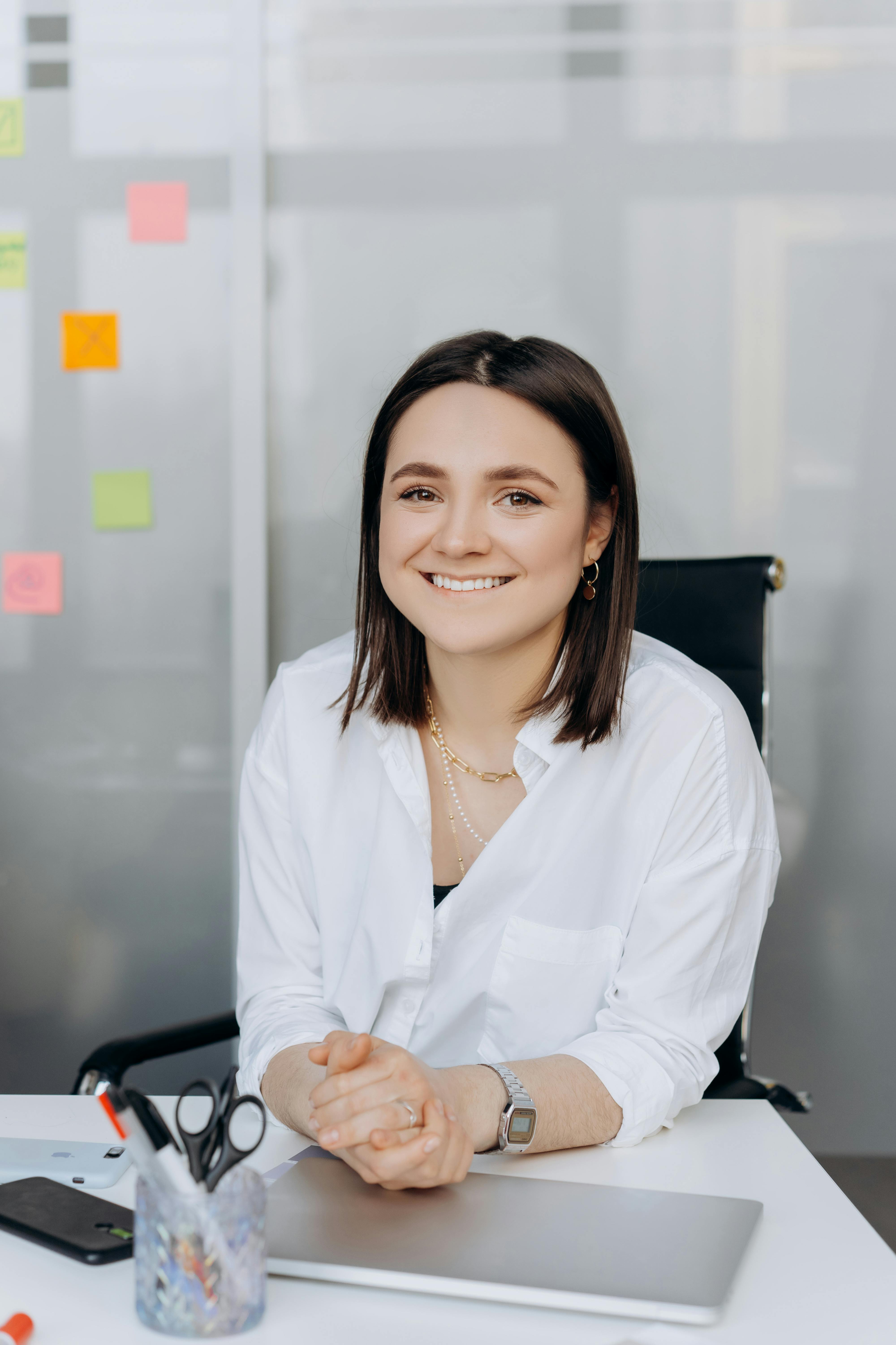 A happy woman in an office | Source: Pexels