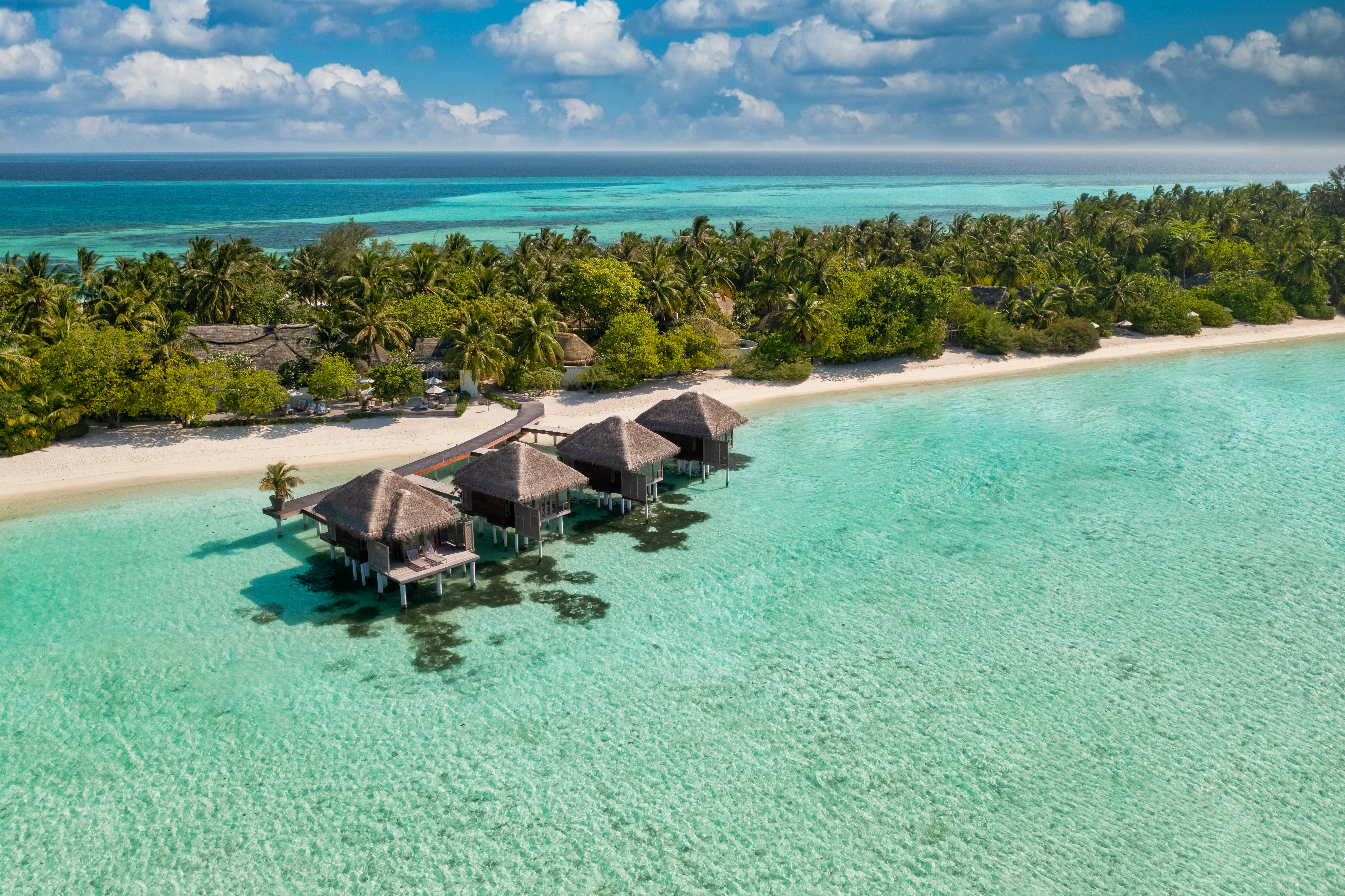 Maldives paradise scenery. Tropical aerial landscape, seascape with long jetty, water villas with amazing sea and lagoon beach, tropical nature. Exotic tourism destination banner, summer vacation | Source: Getty Images