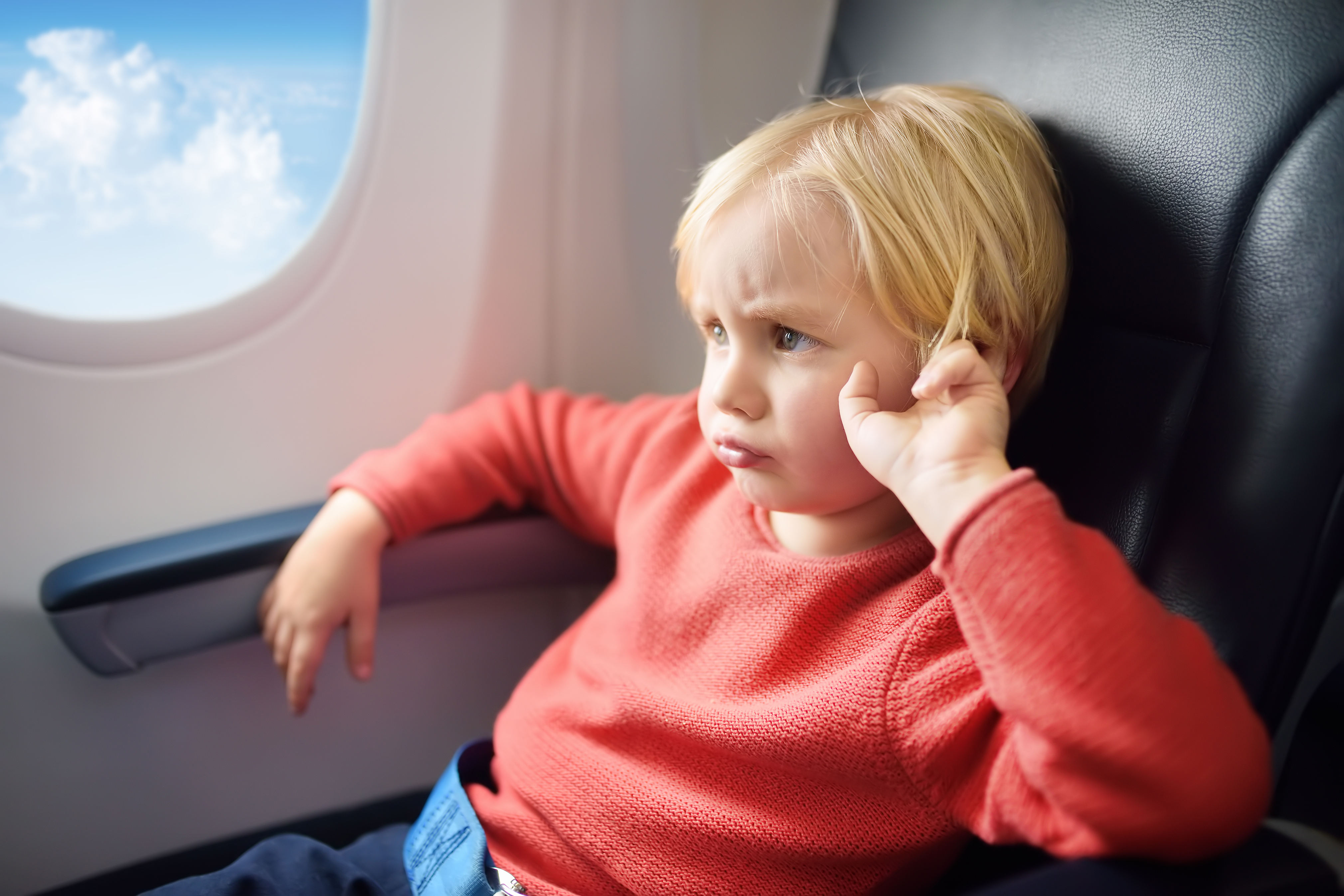 An upset child on an airplane | Source: Shutterstock