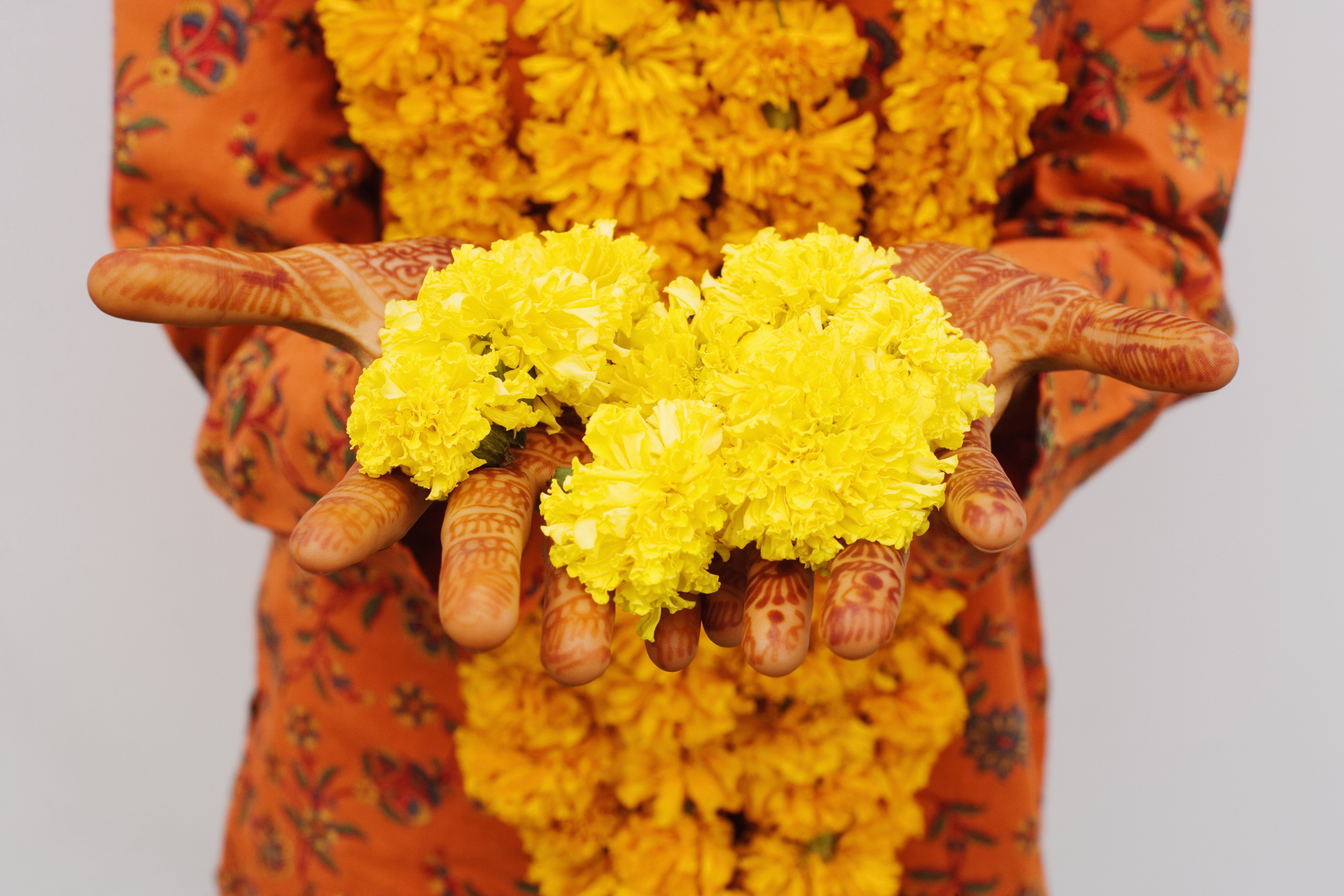 Woman holding marigolds. | Source: Getty Images