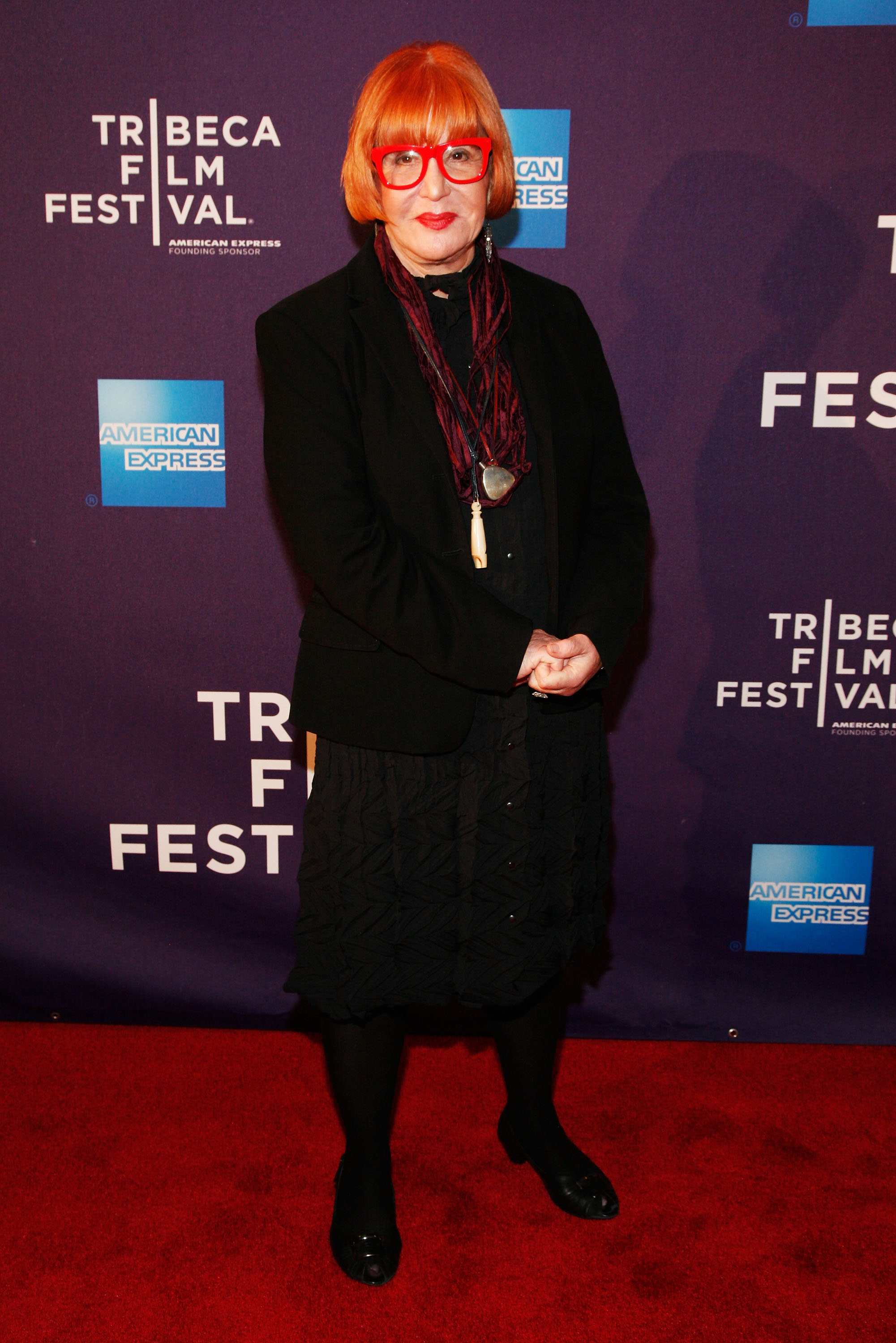 Sally Jessy Raphael walks the red carpet at the premiere of "Évocateur: The Morton Downey Jr. Movie" during the Tribeca Film Festival, held at Clearview Chelsea Cinemas in New York City on April 19, 2012. Dressed in all black with a statement necklace and her iconic red glasses, Raphael makes a rare public appearance.