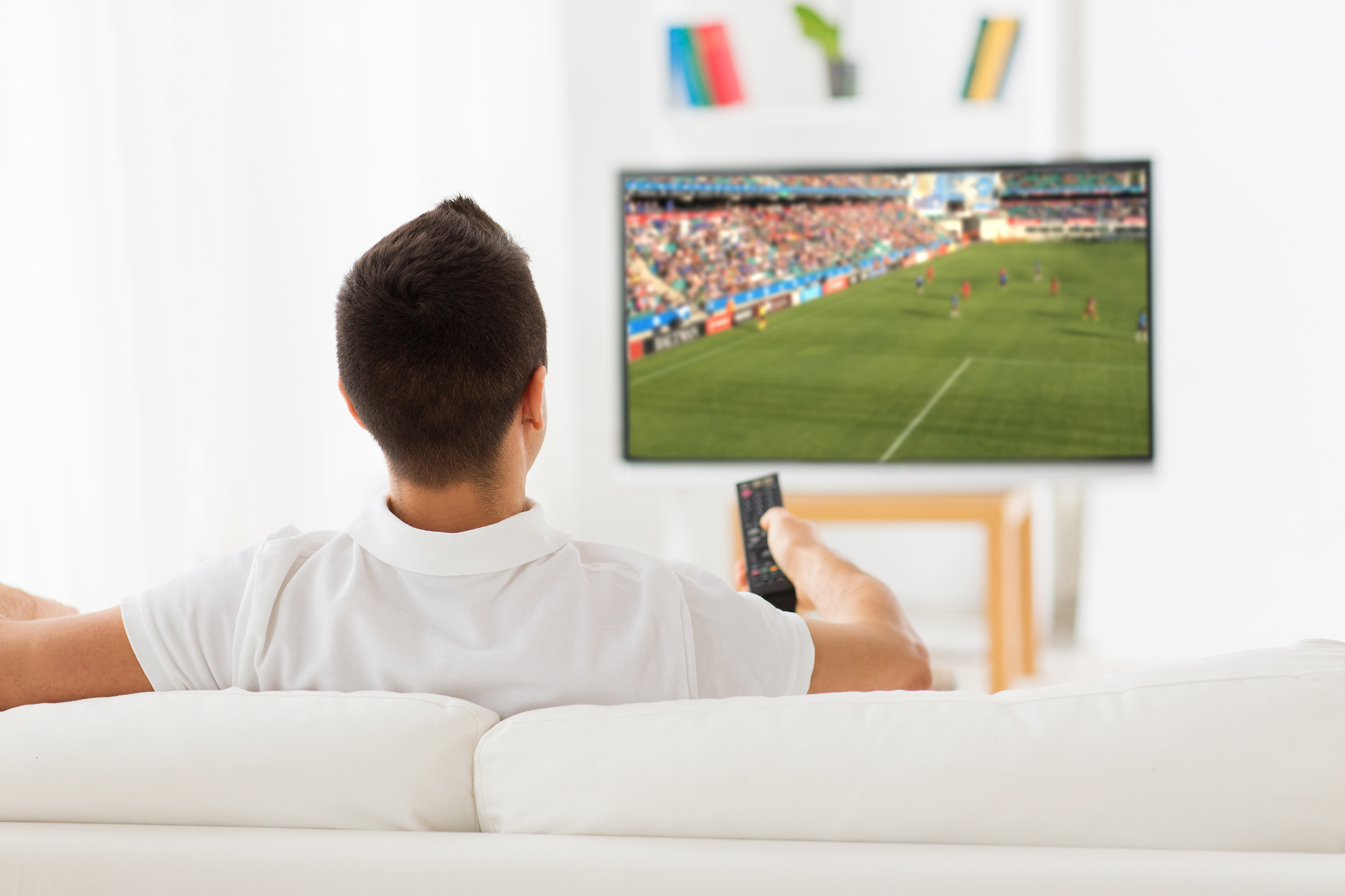 The man was watching TV during the family gathering. | Source: Shutterstock