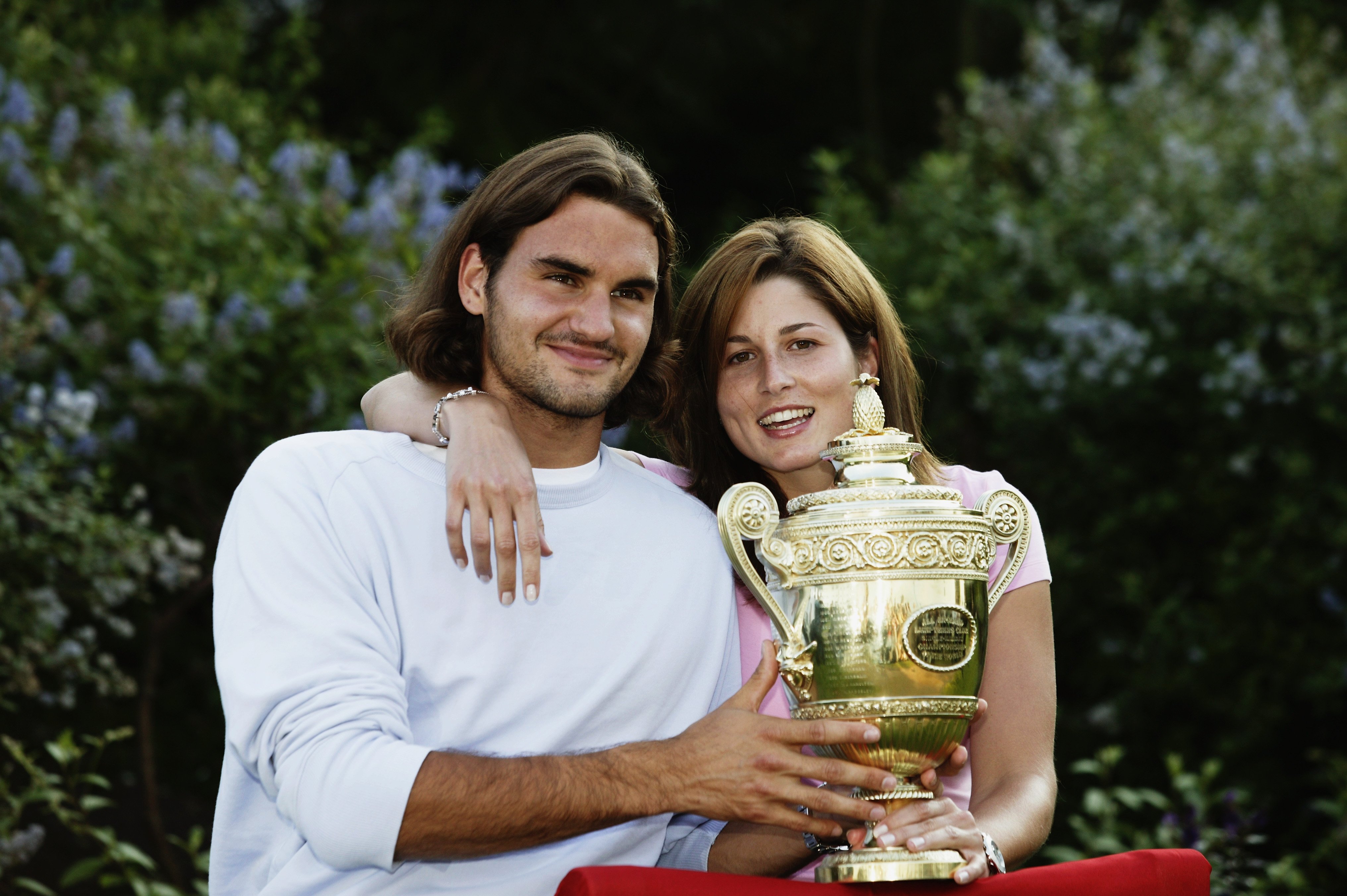 Men's Singles champion Roger Federer poses with Miroslava Vavrinec and the trophy after his victory in the Men's Singles Final during the final day of the Wimbledon Lawn Tennis Championships held on July 6, 2003 in Wimbledon, London. | Source: Getty Images