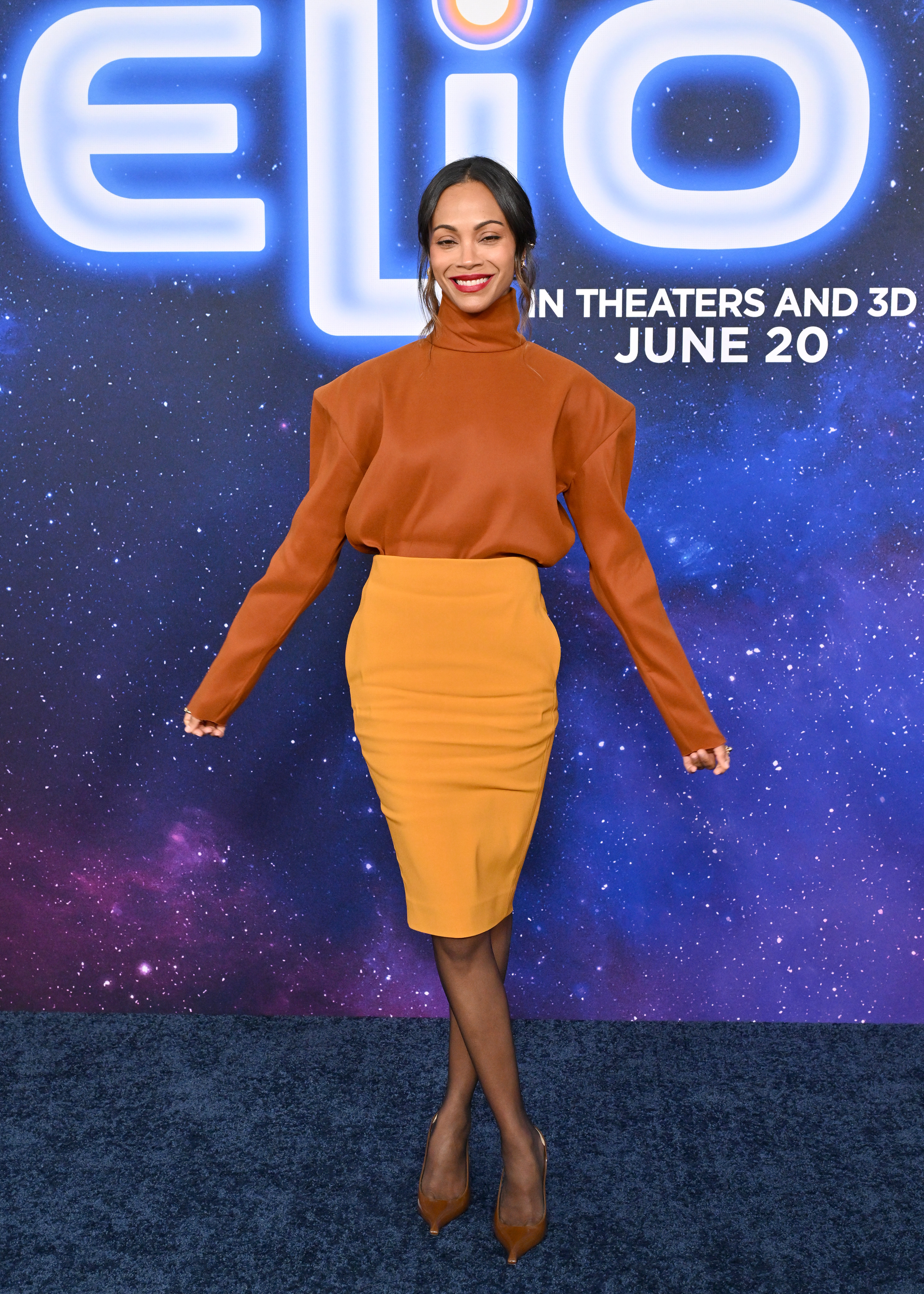 Zoe Saldaña poses solo on the red carpet of Disney Pixar's "Elio" premiere at El Capitan Theatre in Los Angeles, California on June 10, 2025.