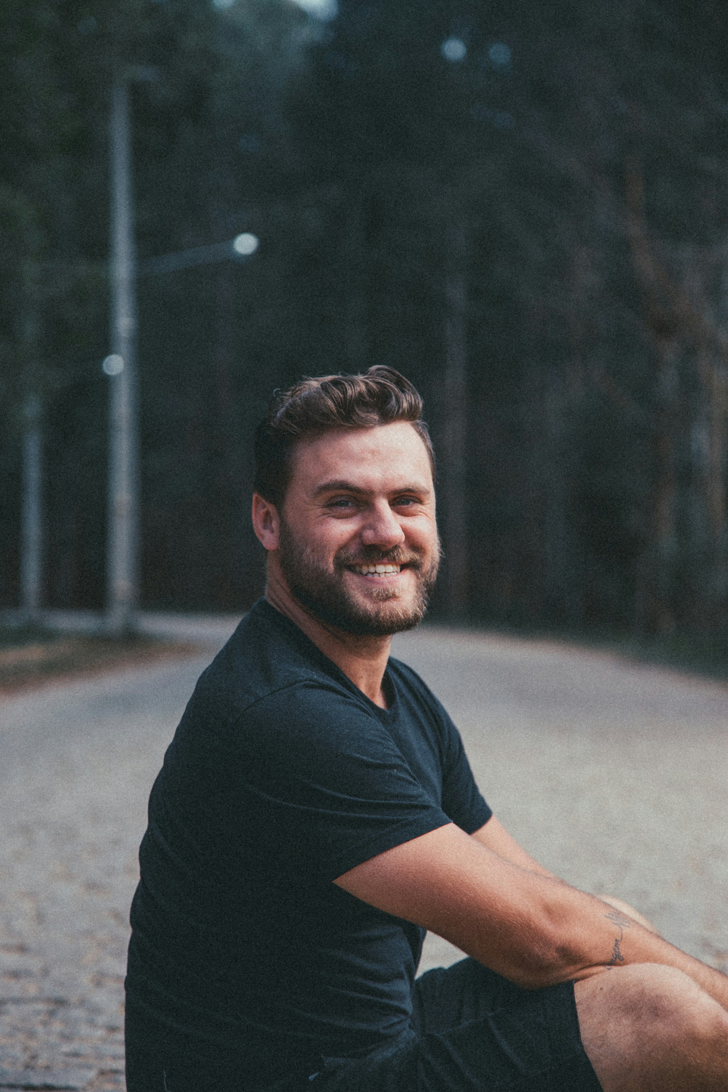 A man sitting and smiling at the camera | Source: Pexels