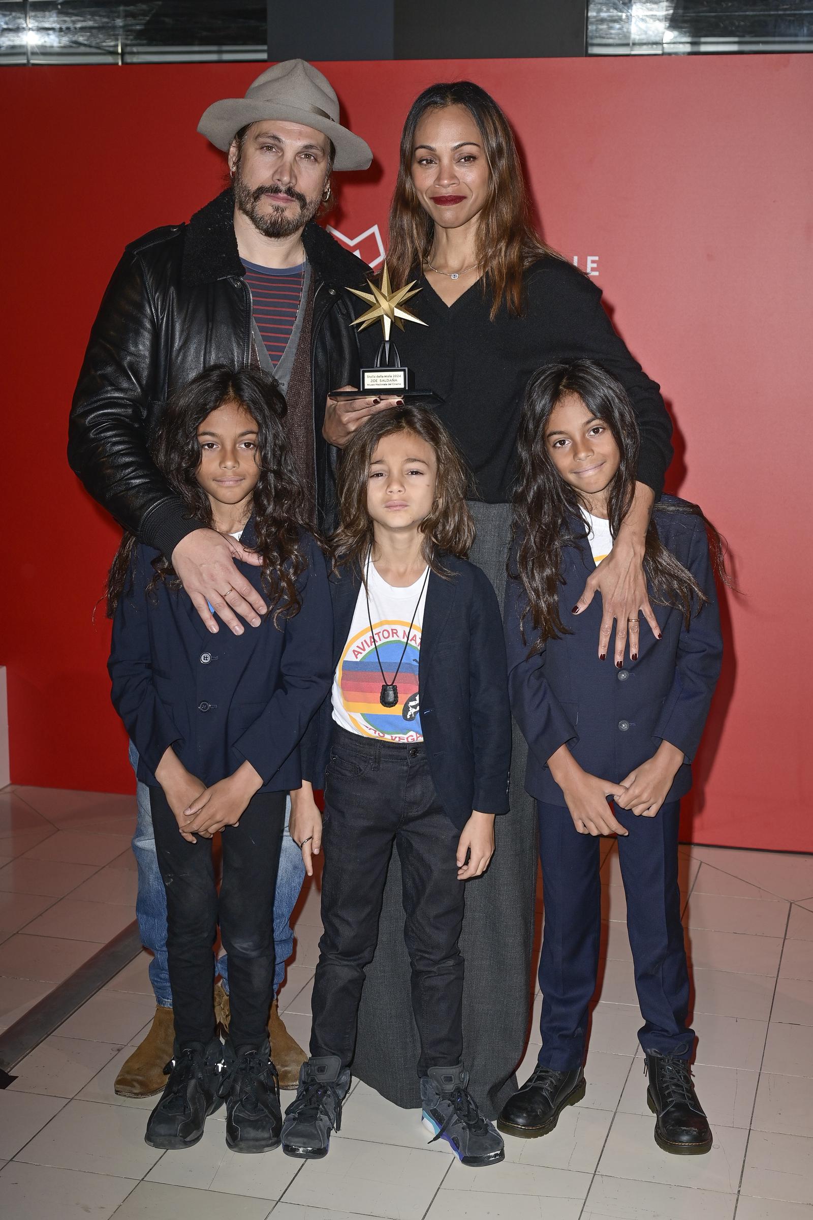 Marco Perego and Zoe Saldaña with their sons, Cy, Bowie, and Zen Perego-Saldaña at the photocall for the "Emilia Perez" premiere. | Source: Getty Images