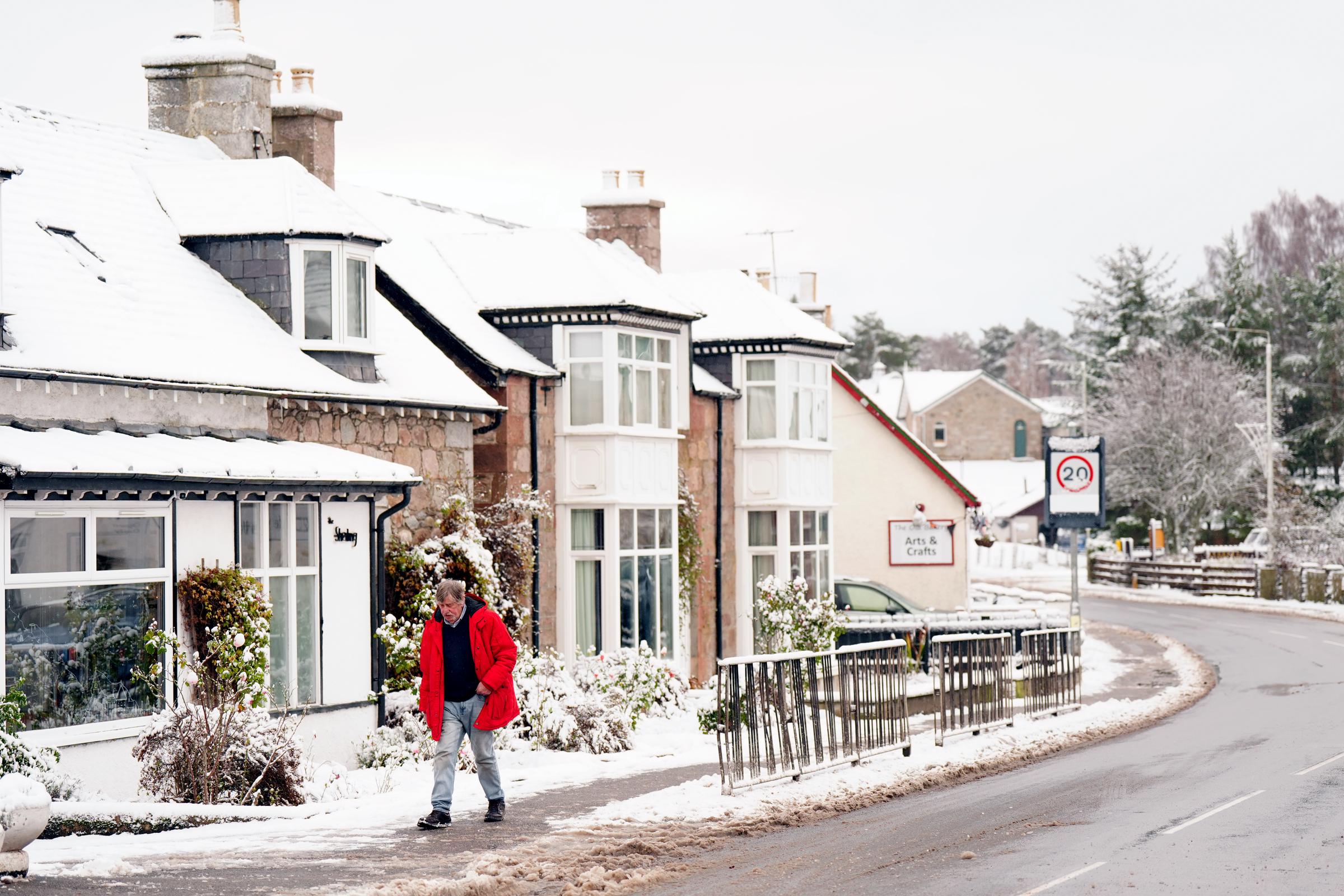 A person walking through snow in Carrbridge in the Scottish Highlands on November 19, 2025. | Source: Getty Images