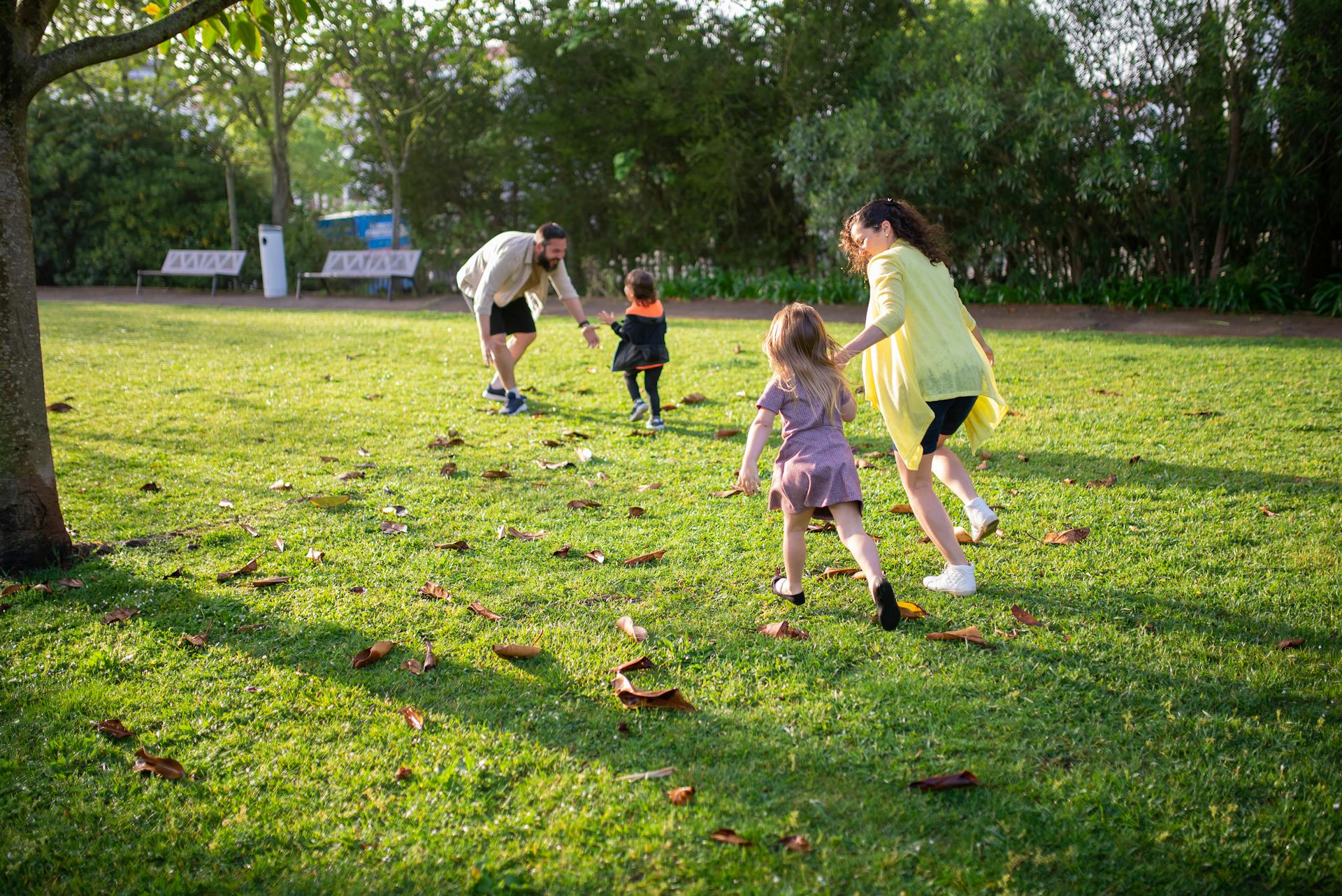 Kids playing in the park with their parents | Source: Pexels