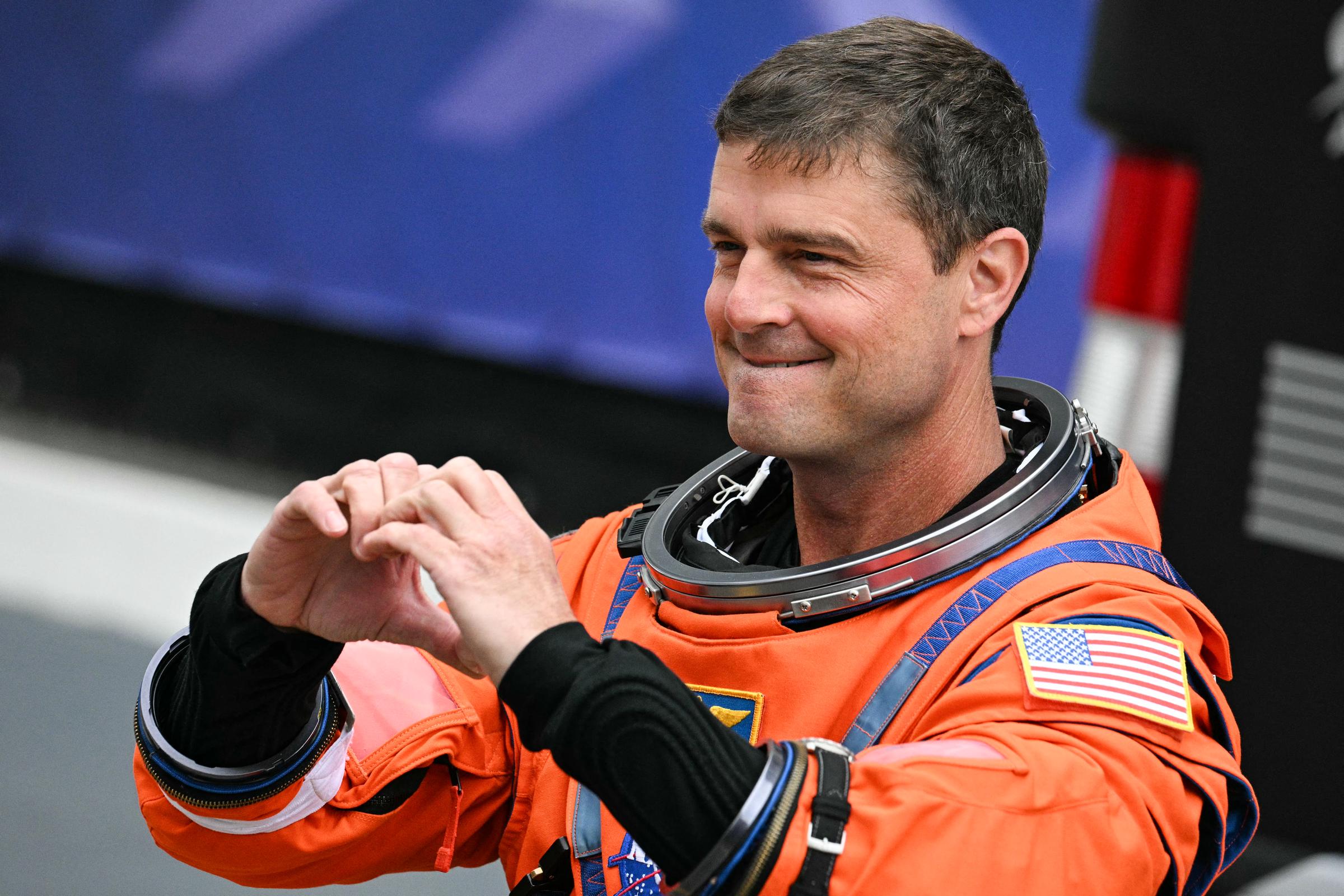 ASA astronaut Reid Wiseman, Artemis II commander, makes a heart sign as he walk out before traveling to the launch pad to board the Space Launch System (SLS) rocket for the Artemis II crewed lunar mission at Kennedy Space Center in Cape Canaveral, Florida, on April 1, 2026. | Source: Getty Images