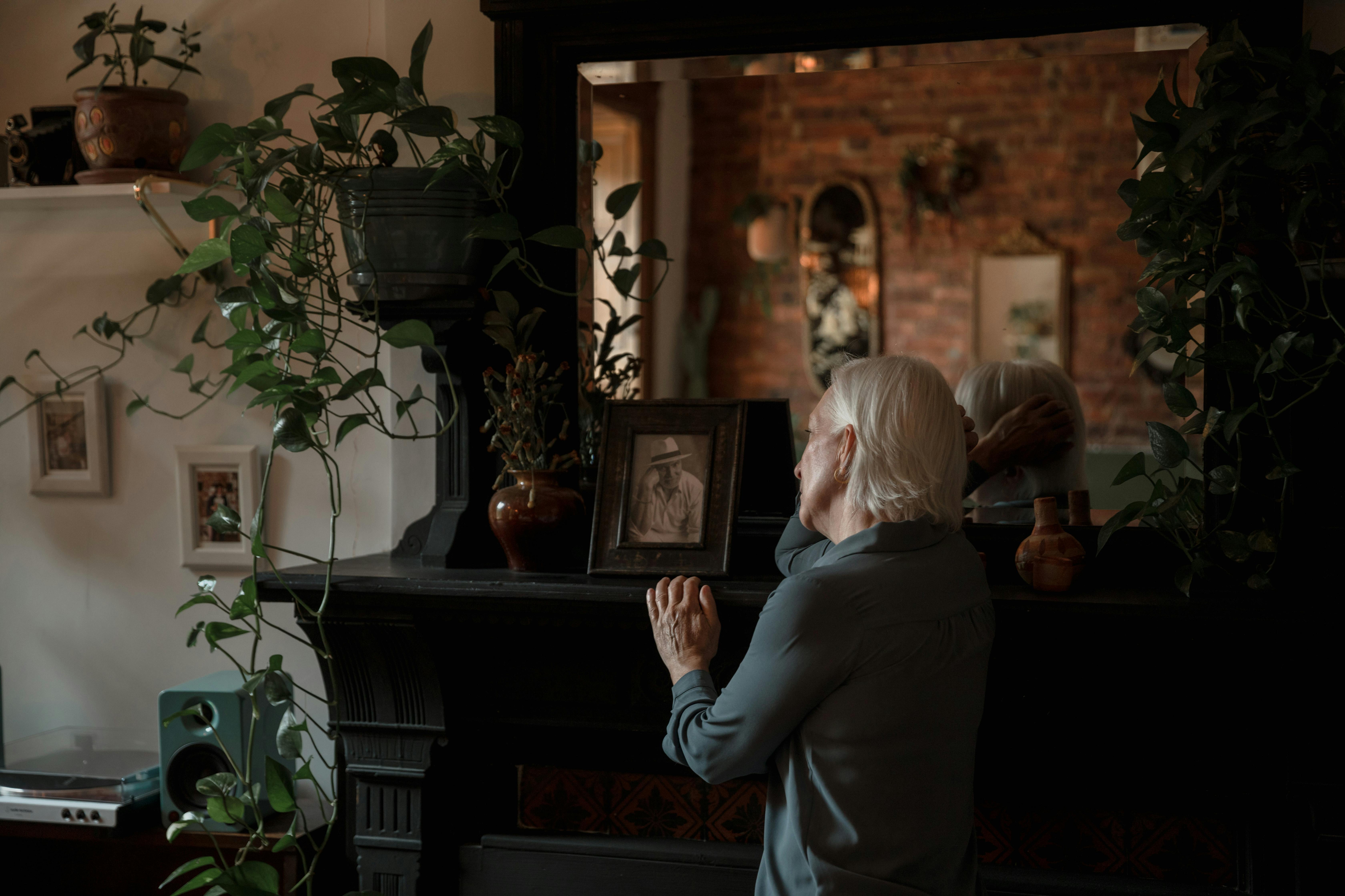 A woman looking at a photo frame | Source: Pexels