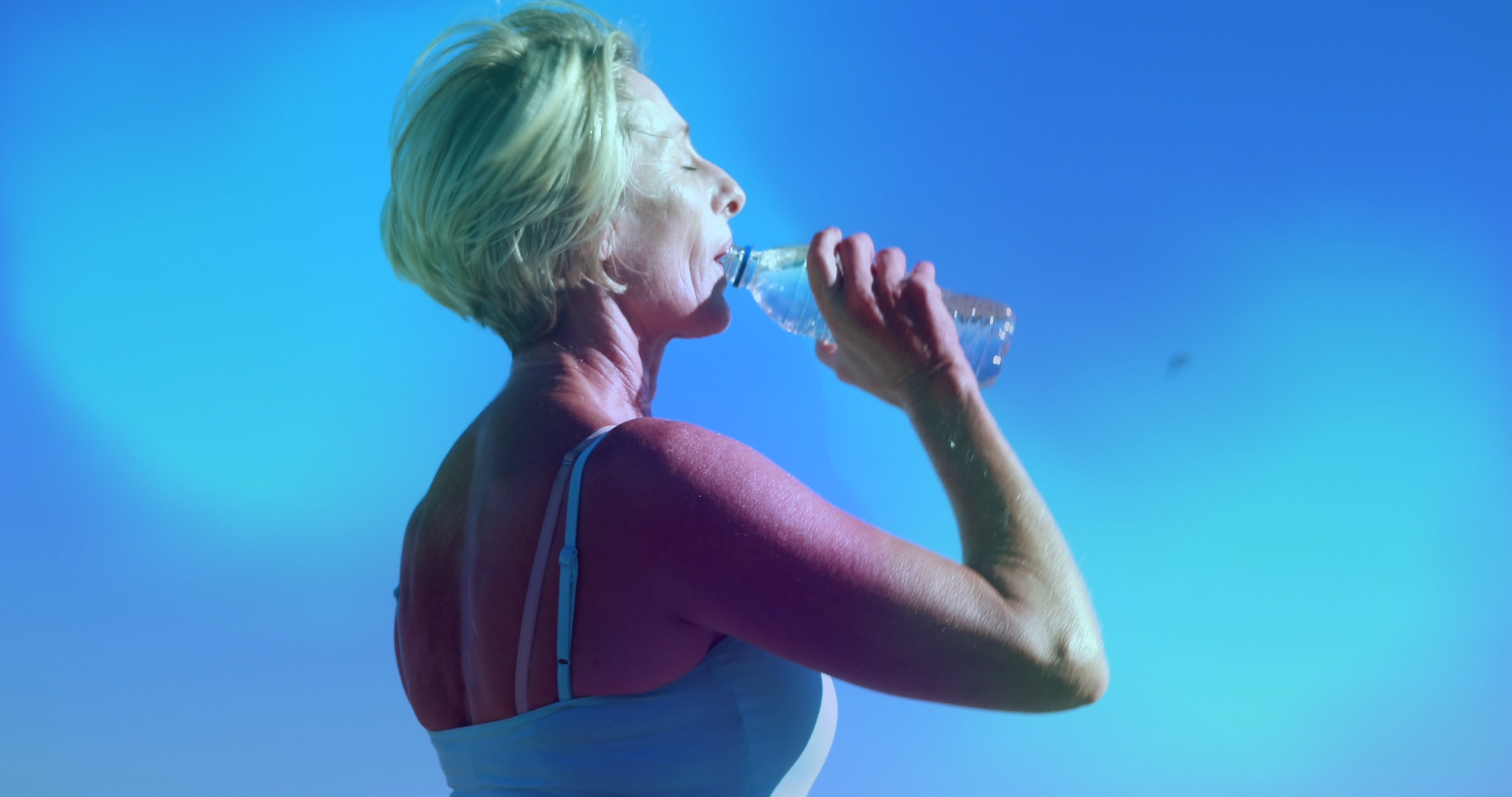 Woman drinking from a bottle of water | Source: Shutterstock