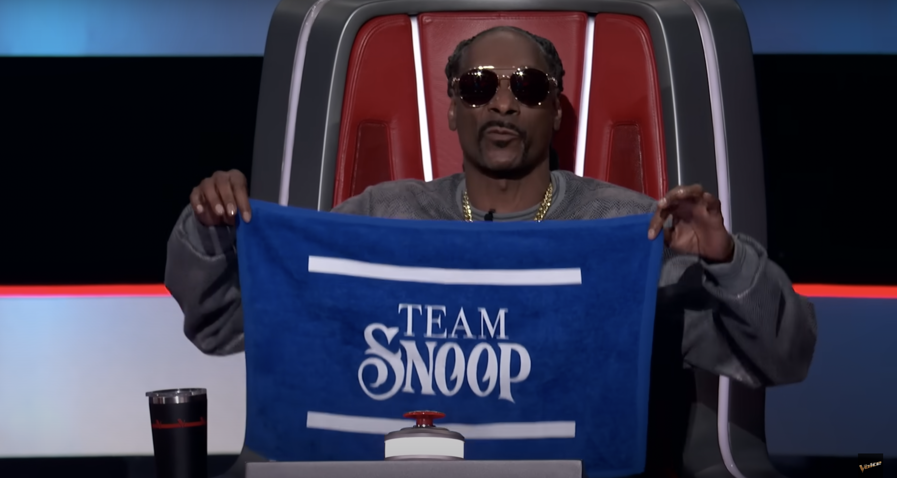 Snoop Dogg holding up a 