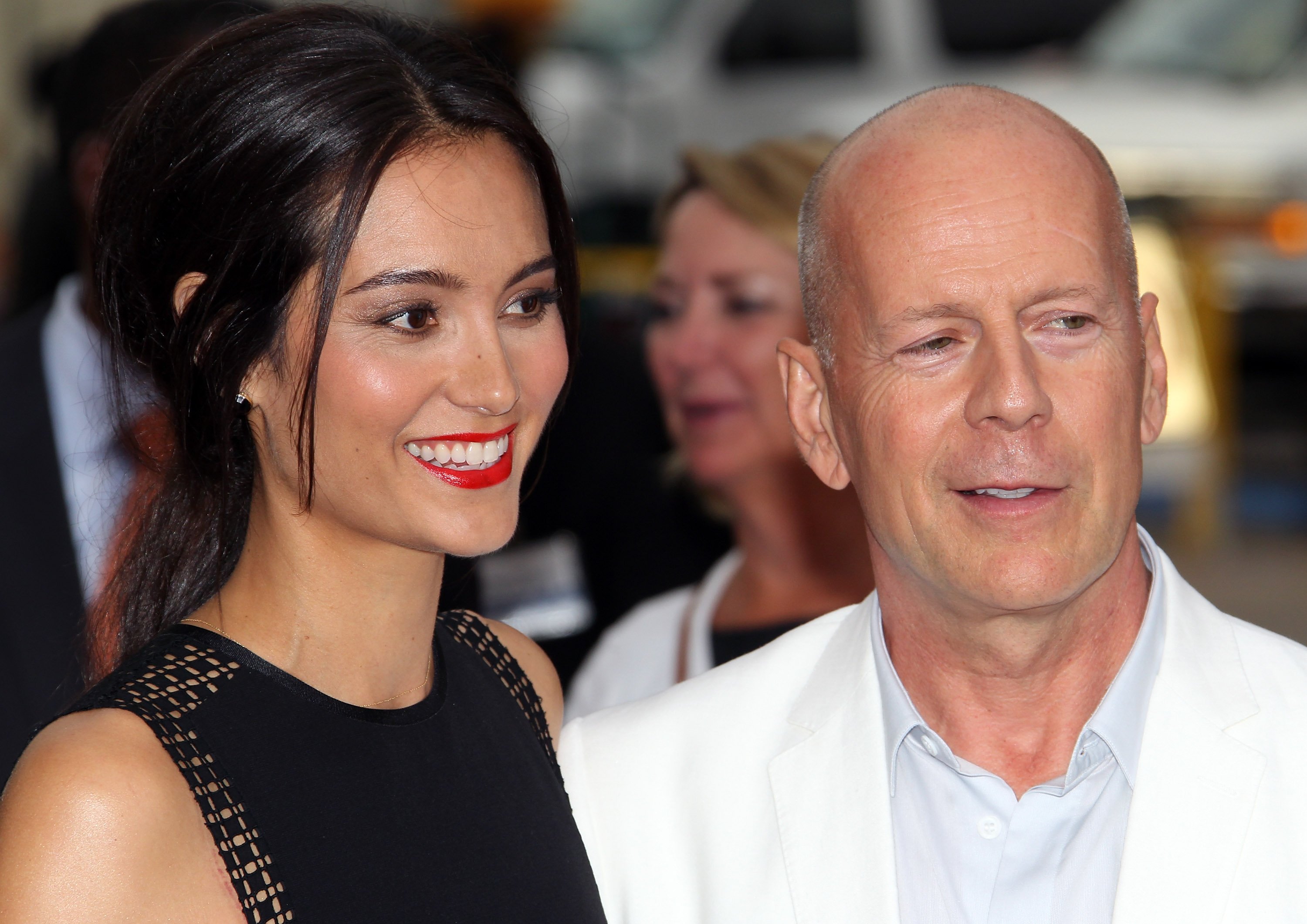  Emma Heming Willis (L) and husband actor Bruce Willis attend the premiere of Summit Entertainment's "RED 2" at Westwood Village on July 11, 2013, in Los Angeles, California. | Source: Getty Images.