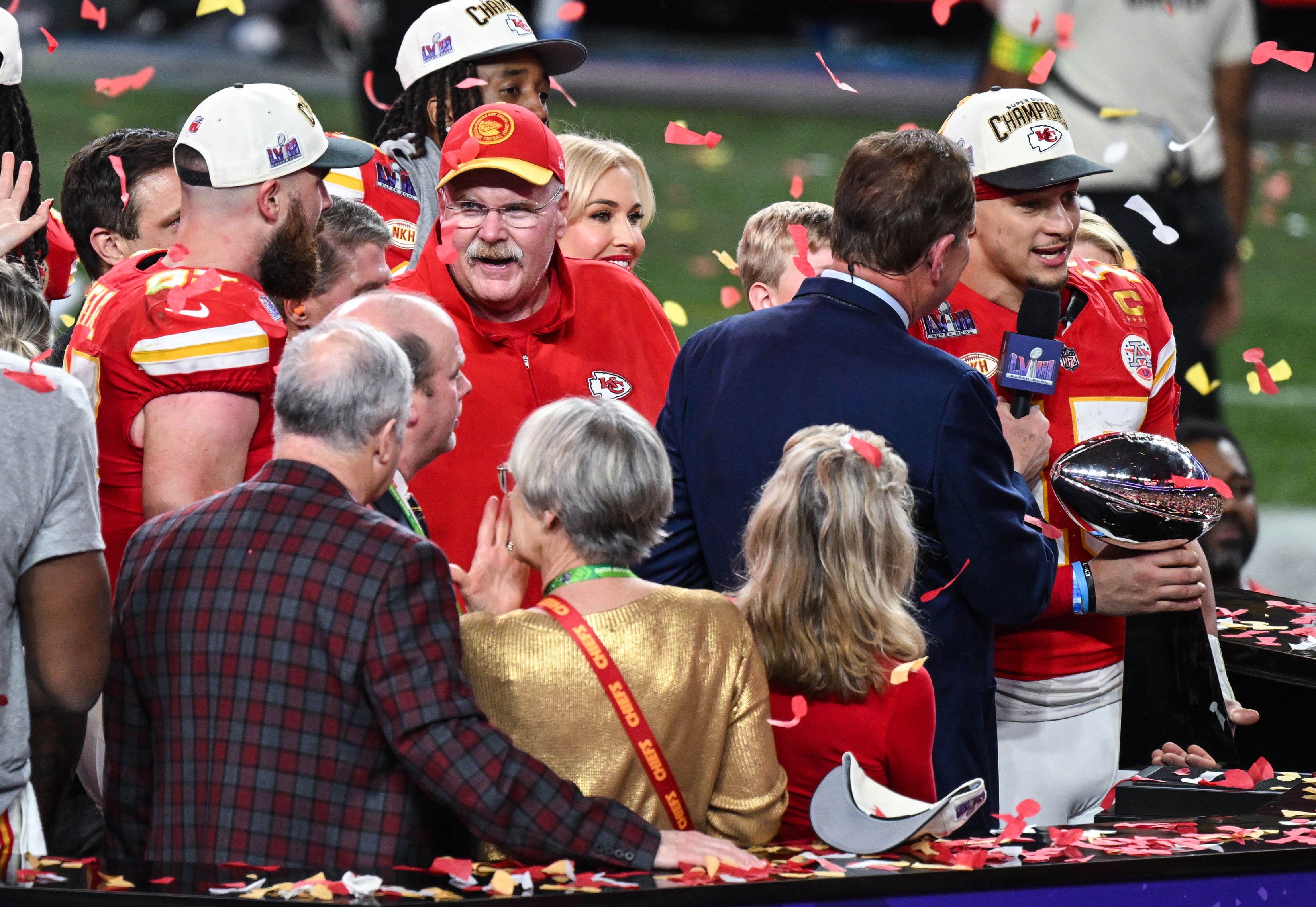 Kansas City Chiefs tight end Travis Kelce, Head Coach Andy Reid and Quarterback Patrick Mahomes celebrate on the podium with the Vince Lombardo Trophy during Super Bowl LVIII on February 11, 2024 in Las Vegas, Nevada | Source: Getty Images