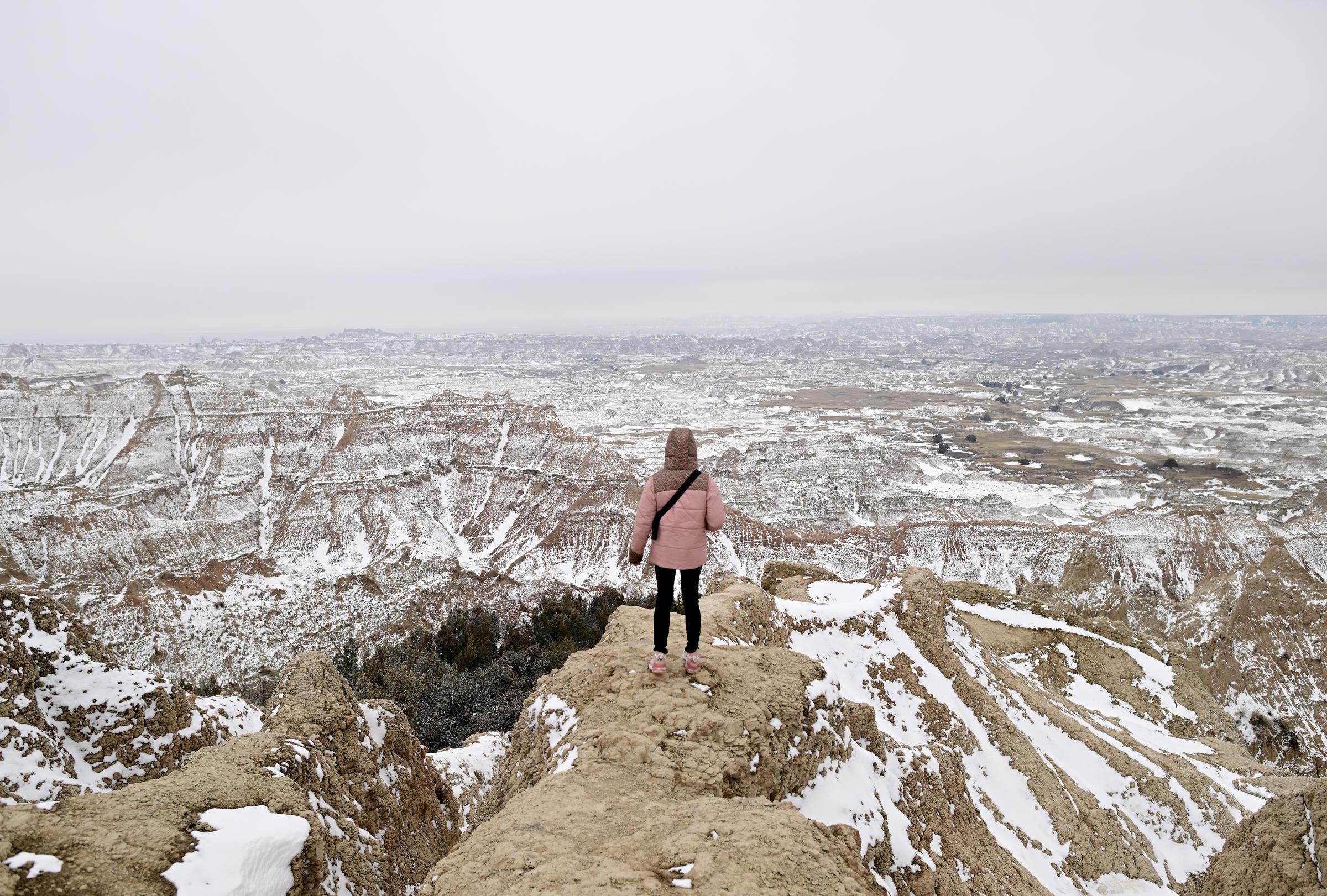 A person stands in Badlands National Park in South Dakota on March 21, 2023 | Source: Getty Images