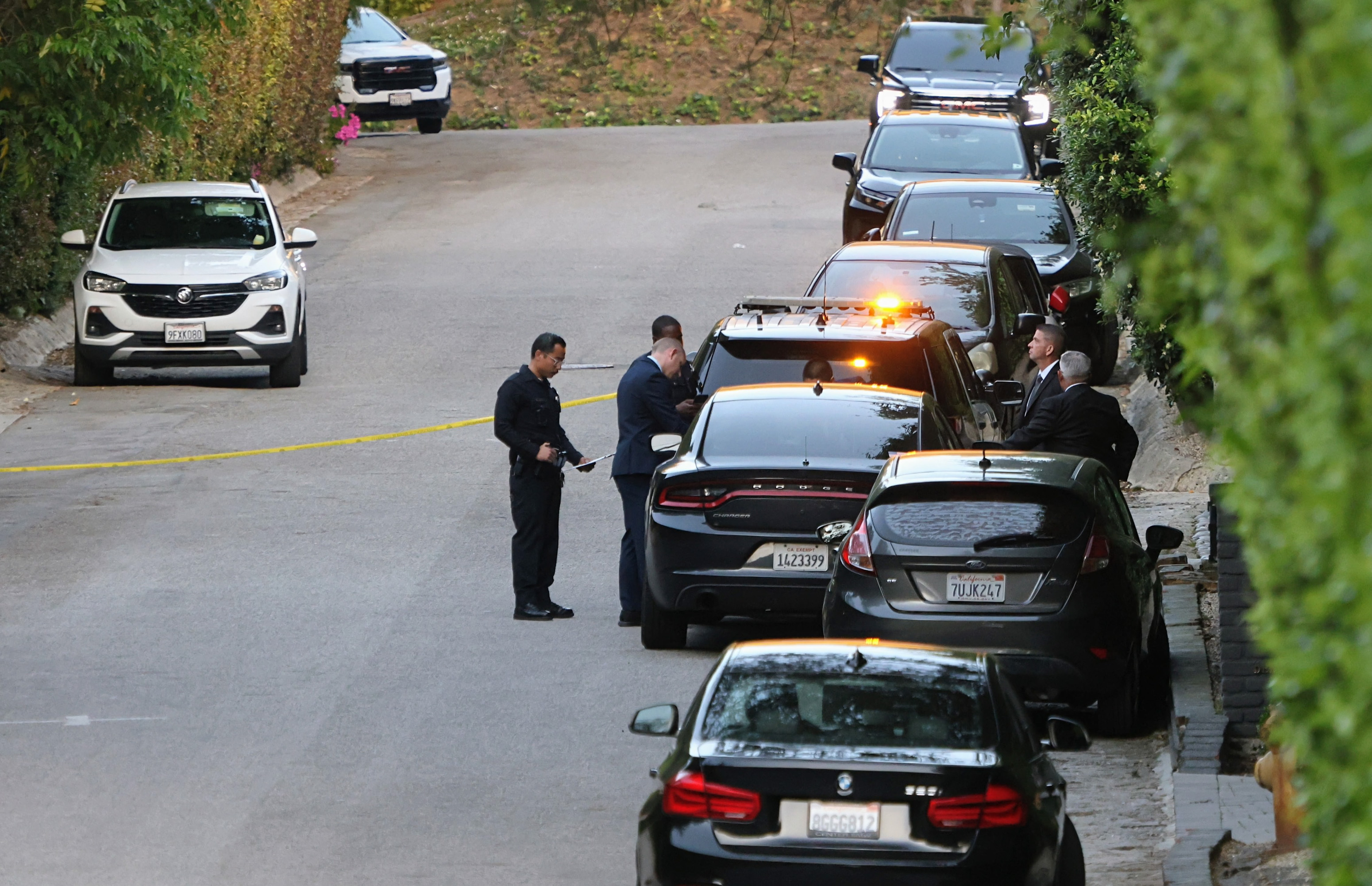 Police officers stand outside Rihanna's home following a report of gunshots on March 8, 2026, in Beverly Hills, California | Source: Getty Images