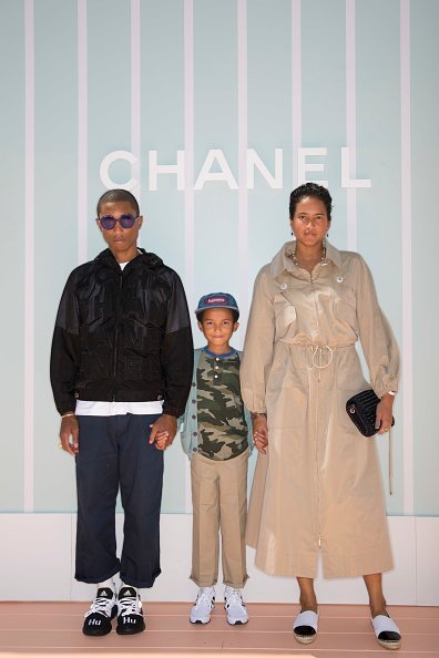 Pharrell Williams, left, Rocket Williams and Helen Williams attend the Chanel Cruise 2018/19 Replica Show at Sermsuk Warehouse Pepsi Pier on October 31, 2018, in Bangkok, Thailand. | Source: Getty Images.