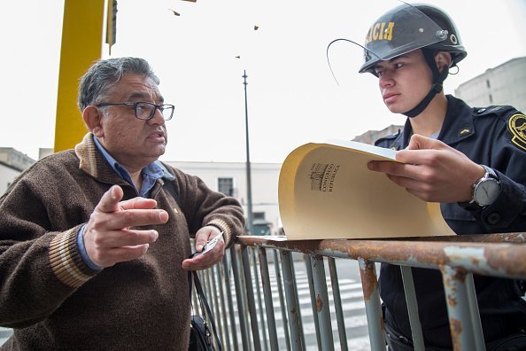 A police officer pictured reviewing the documentation of a citizen | Photo: Getty Images