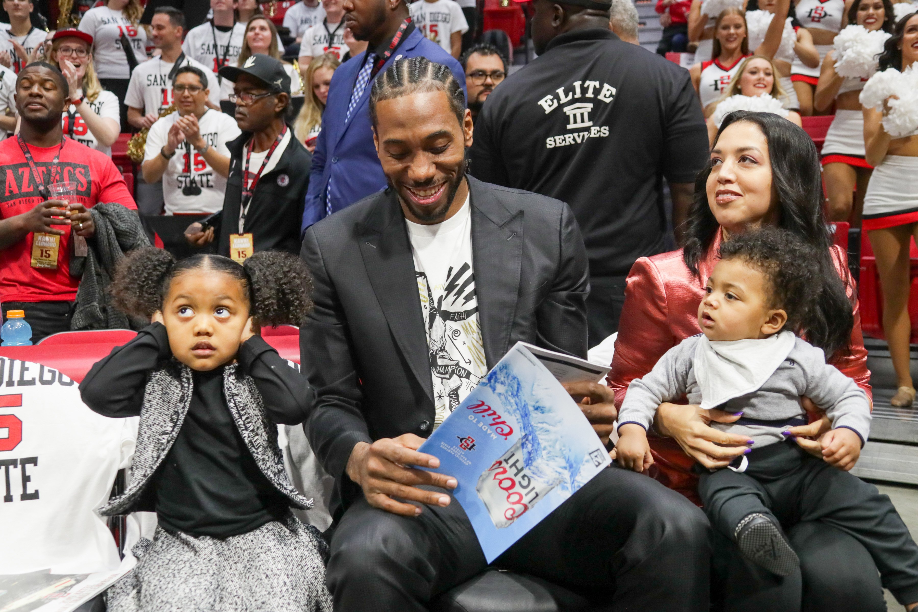 Kawhi Leonard sits with his family during the first half of the game against the Utah State Aggies at Viejas Arena, on February 1, 2020, in San Diego, California. | Source: Getty Images