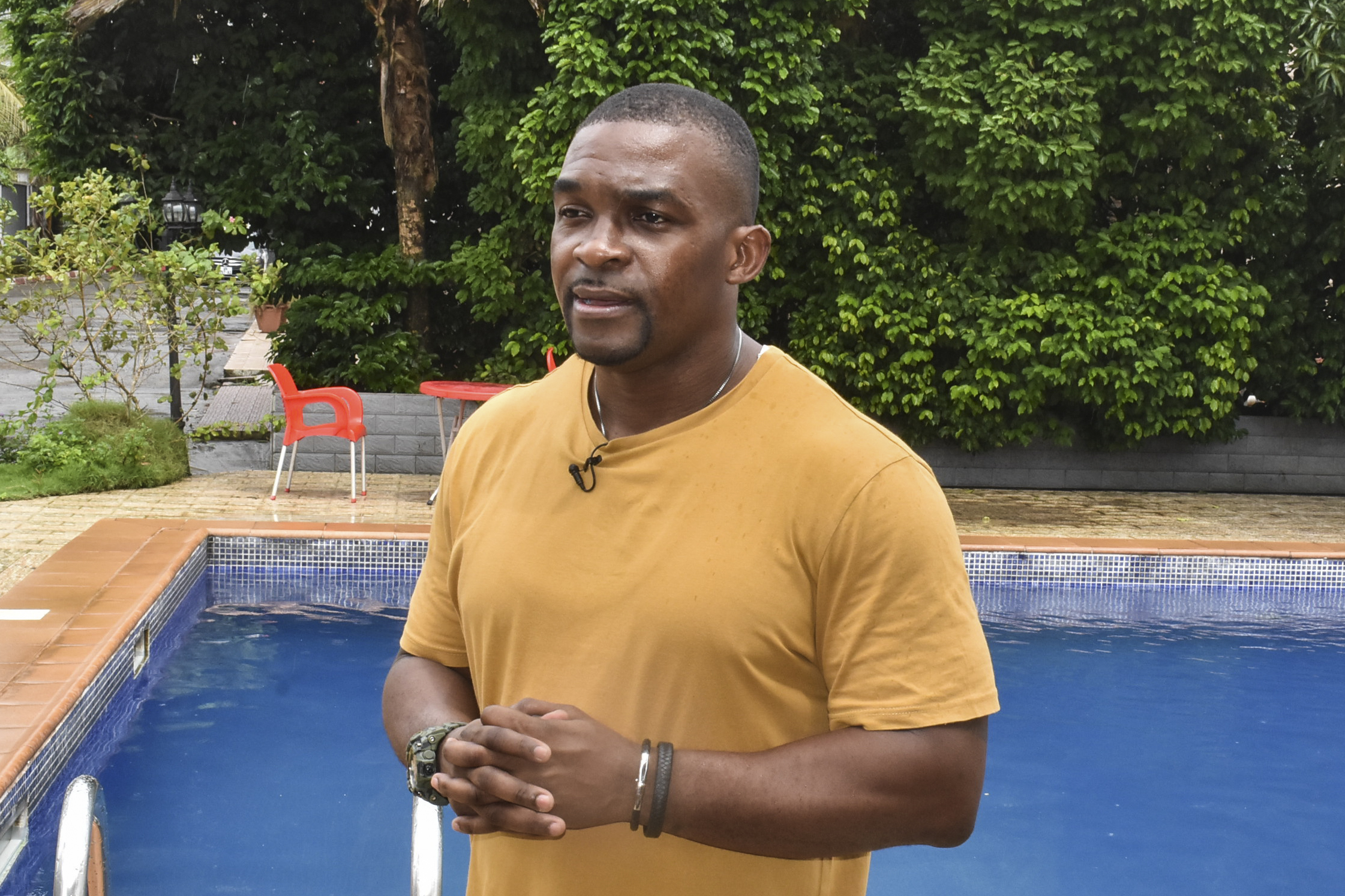 Eric Moussambani speaks with AFP while standing next to a 12m long swimming pool, similar to the one he used to train while preparing for the Olympics, at the CHN Flat-Hotel in Malabo on September 12, 2020 | Source: Getty Images