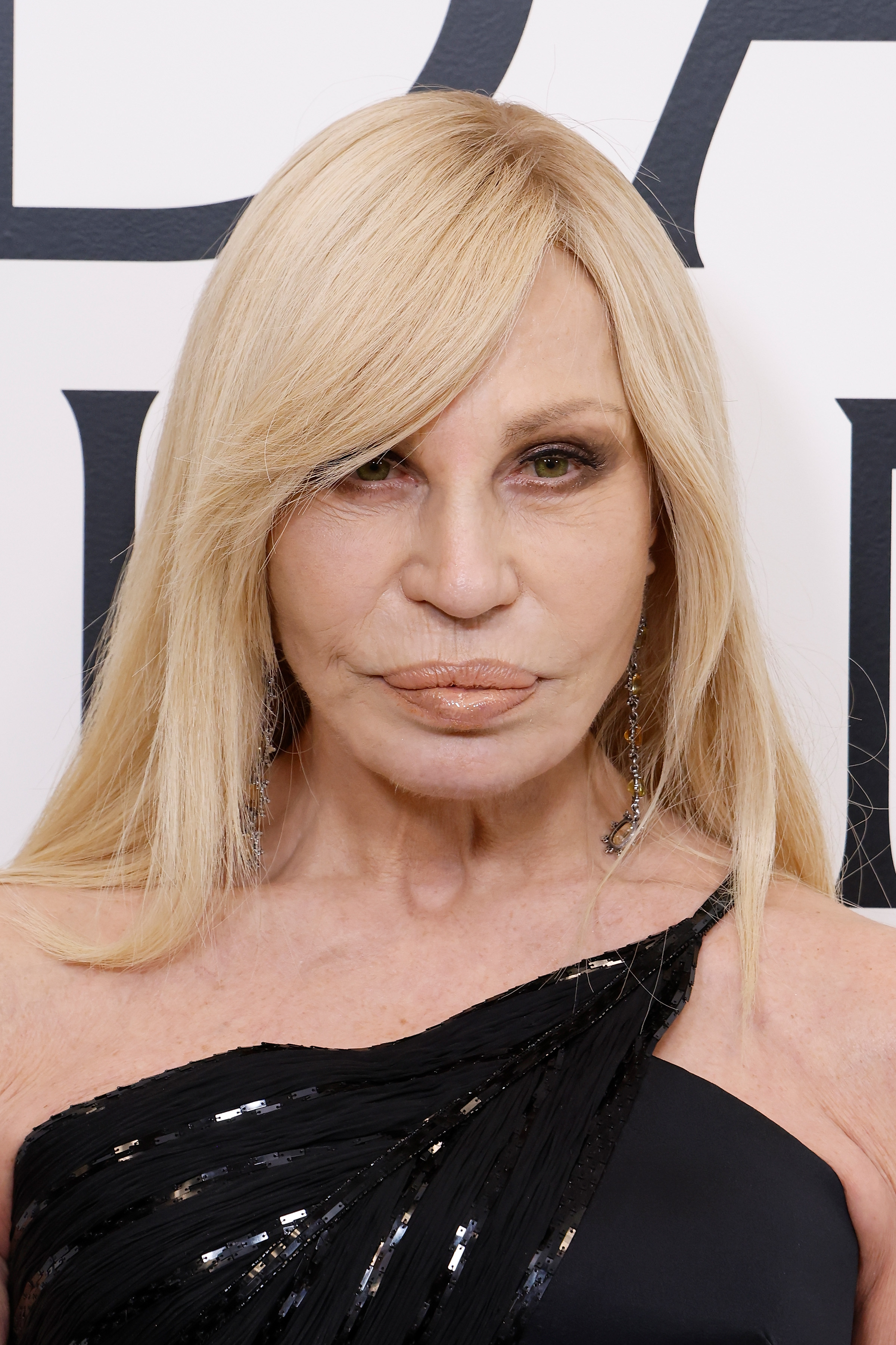 Donatella Versace, 70, attended the CFDA Awards Winners' Walk on November 3, 2025, at the American Museum of Natural History in New York City. Her face showed a noticeably softer and aged appearance, but still voluminous lips, defined jawline contour, and smooth cheeks beneath her heavily lined eyes.