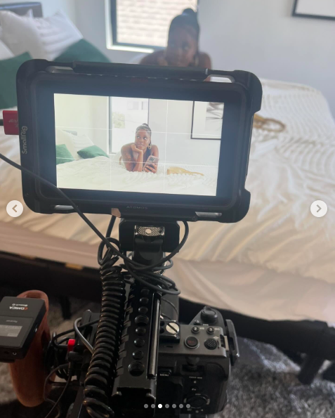 A camera monitor showing Alysha Burney lying on a bed with her phone. | Source: Instagram/alyshaburney_