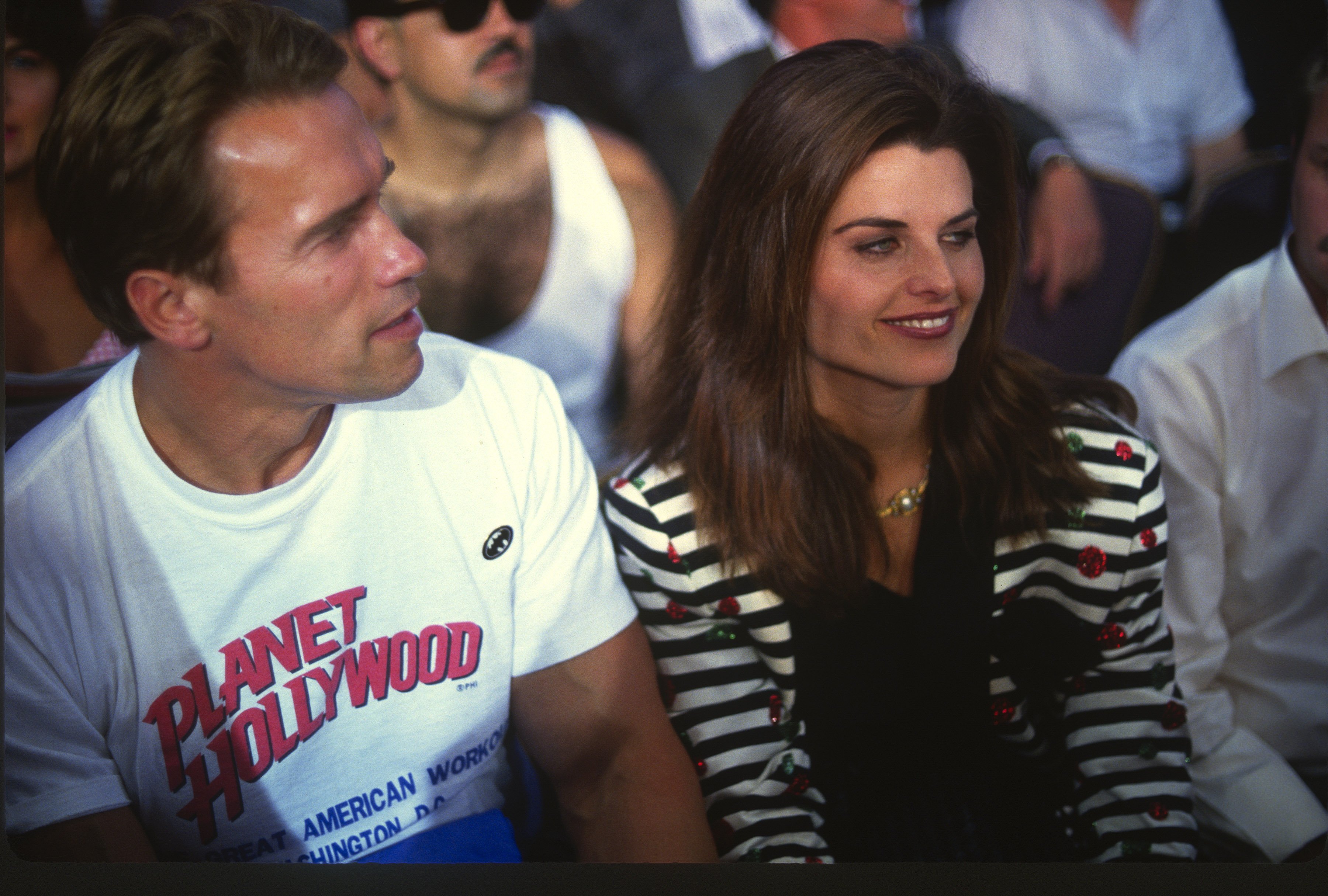 Arnold Schwarzenegger and his wife Maria Shriver look on during the WBC, WBA, and IBF heavyweight title fight between Larry Holmes and Evander Holyfield on June 19, 1992, at Caesars Palace in Las Vegas, Nevada. | Source: Getty Images